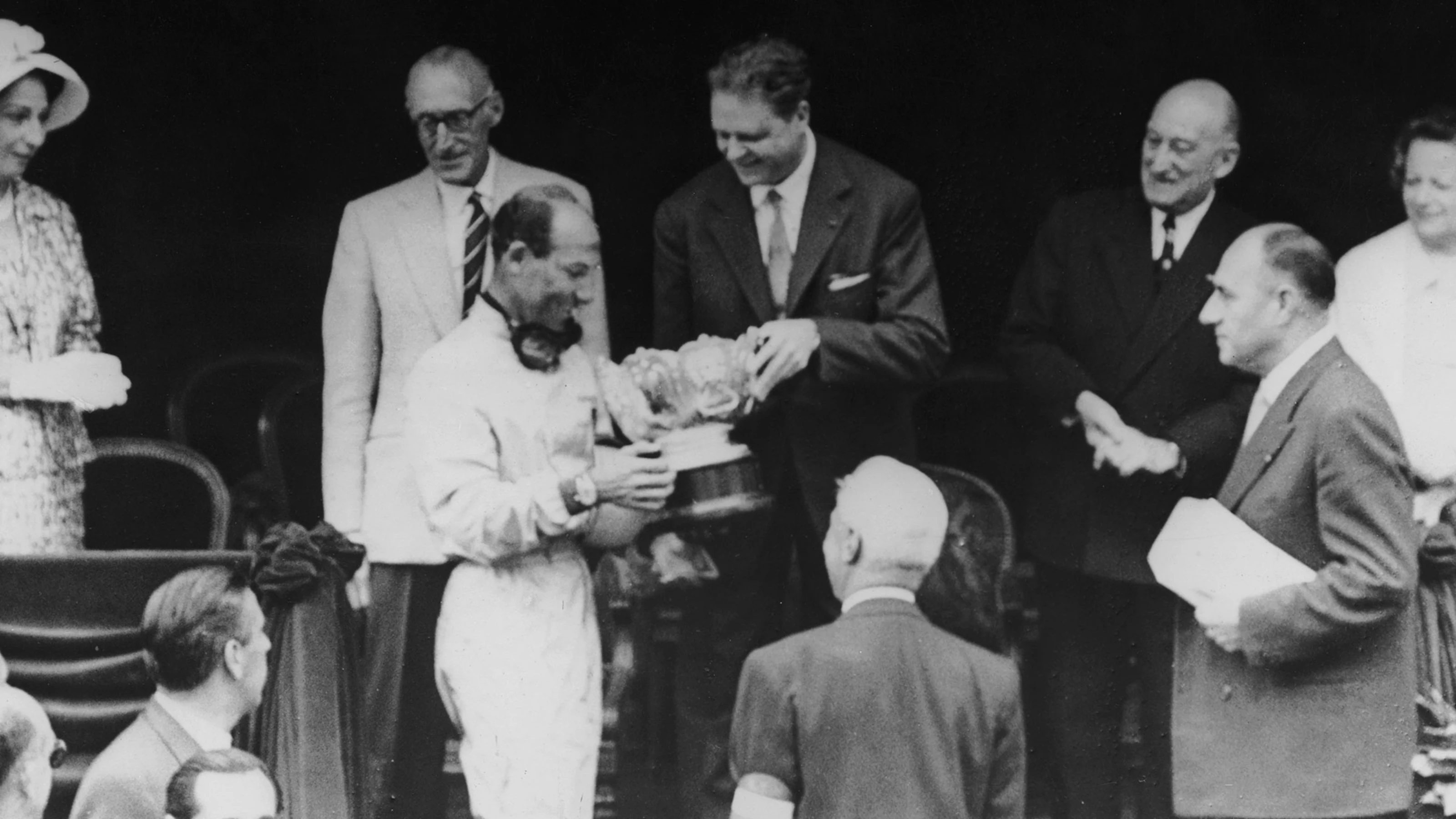 English racing driver Stirling Moss receives his trophy after winning the Monaco Grand Prix at