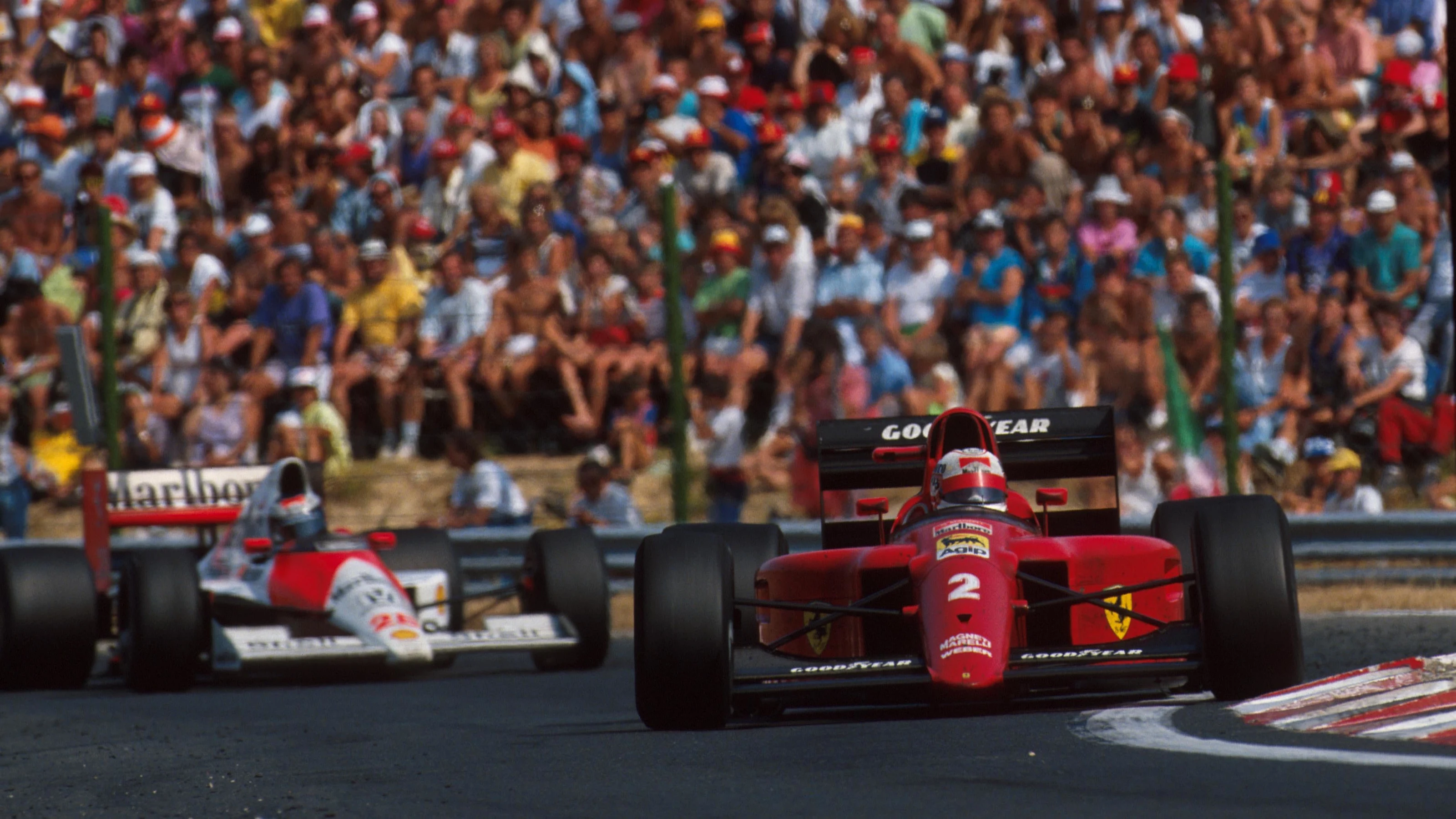 the Ferrari of Nigel Mansell leads the McLaren of Gerhard Berger Hungarian GP, Budapest, Hungary,