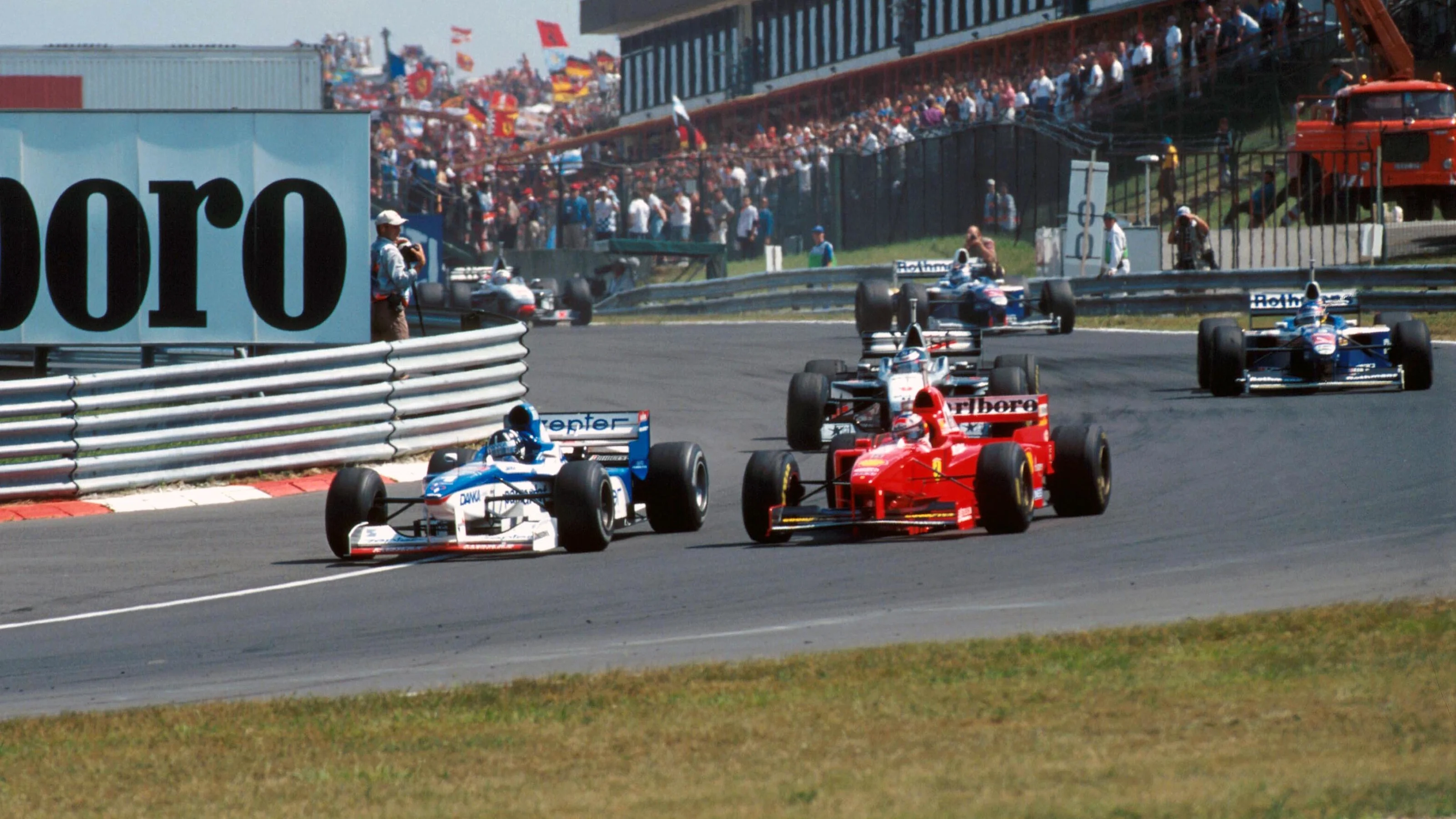 Damon Hill (GBR) Arrows A18 overtakes Michael Schumacher (GER) Ferrari F310B Formula One World