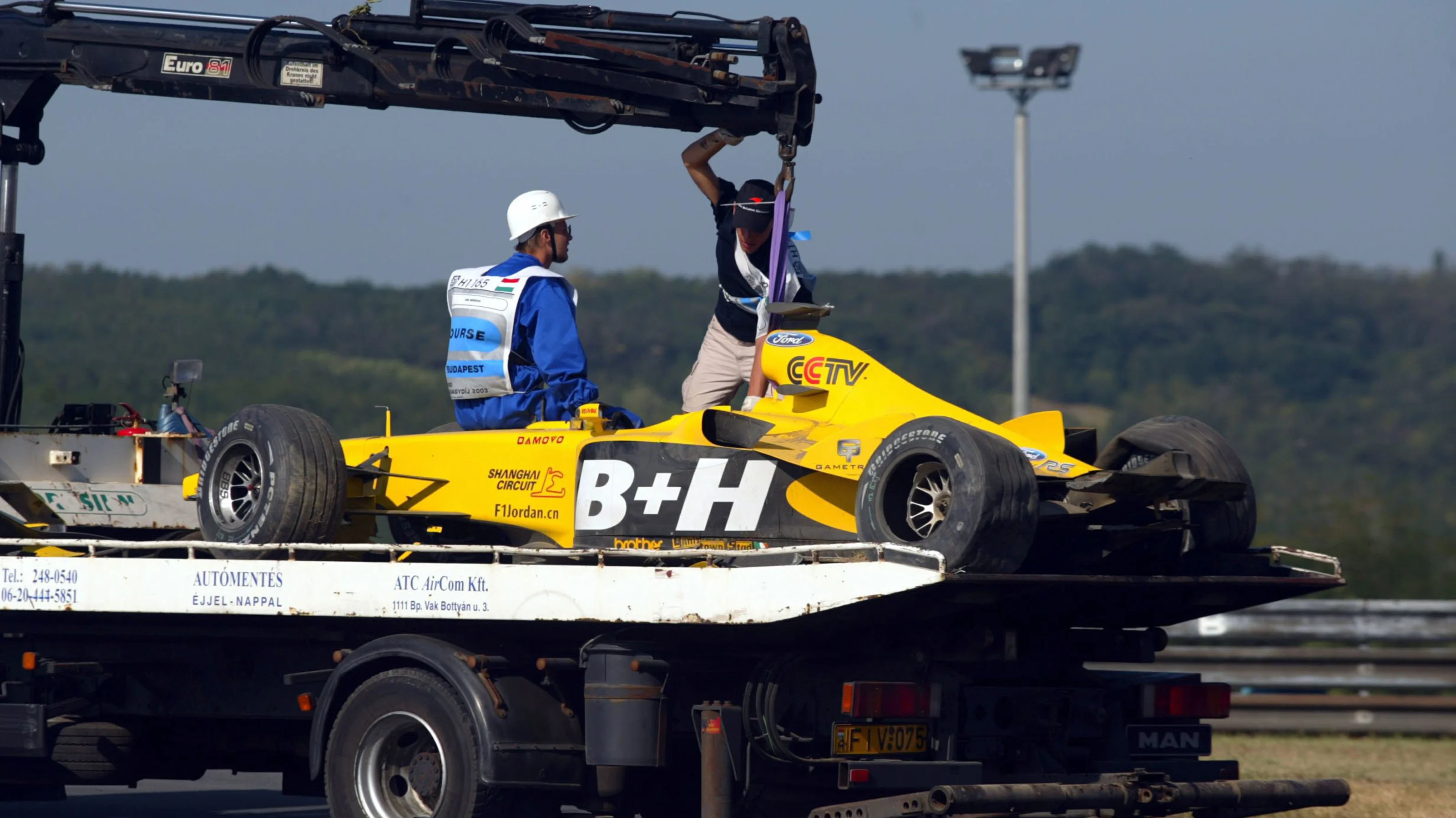 The Jordan Ford EJ13 of Ralph Firman Jnr (GBR) is returned to the paddock on a truck after his