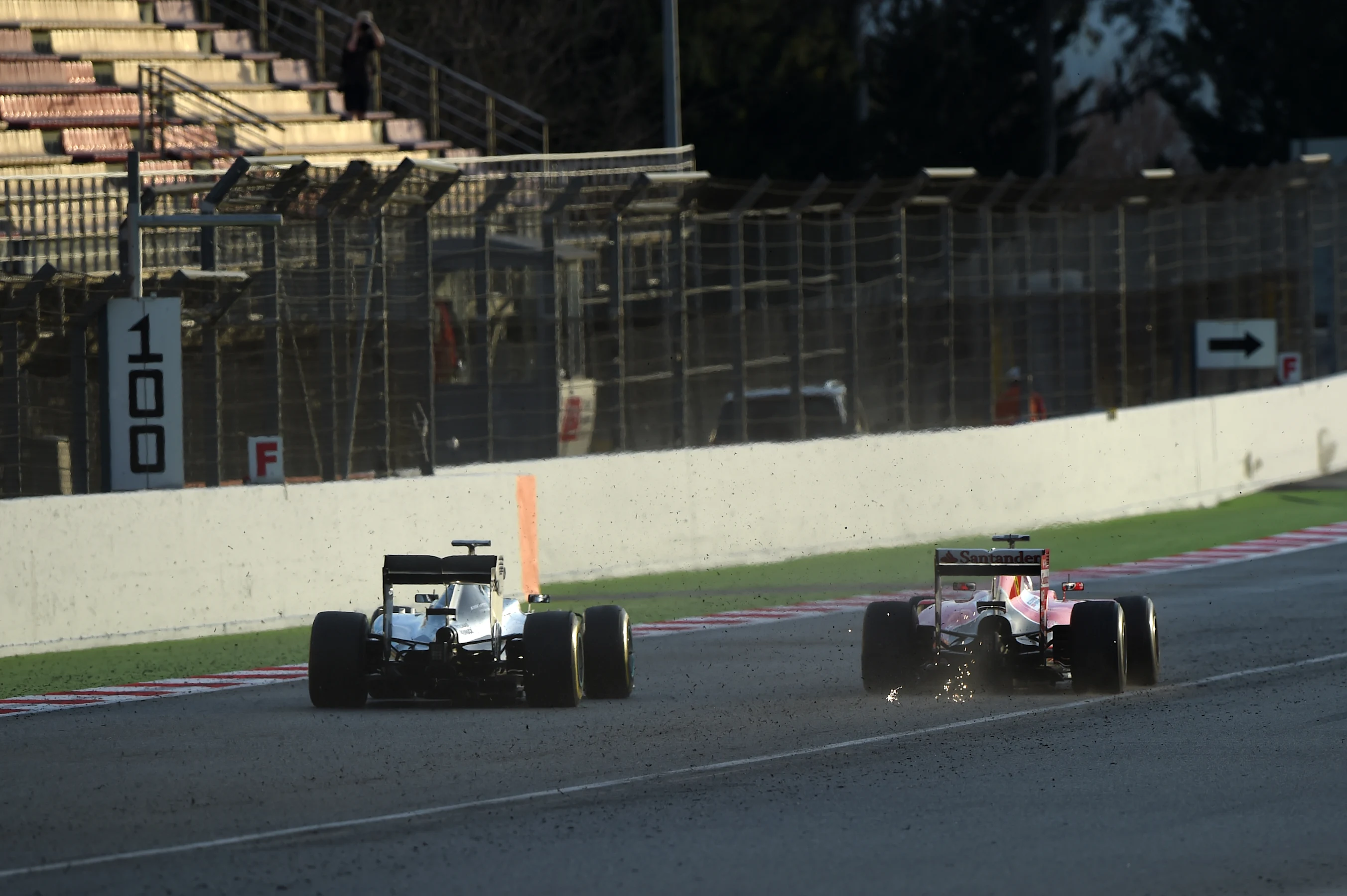 Nico Rosberg (GER) Mercedes AMG F1 W06 and Sebastian Vettel (GER) Ferrari SF15-T with sparks at
