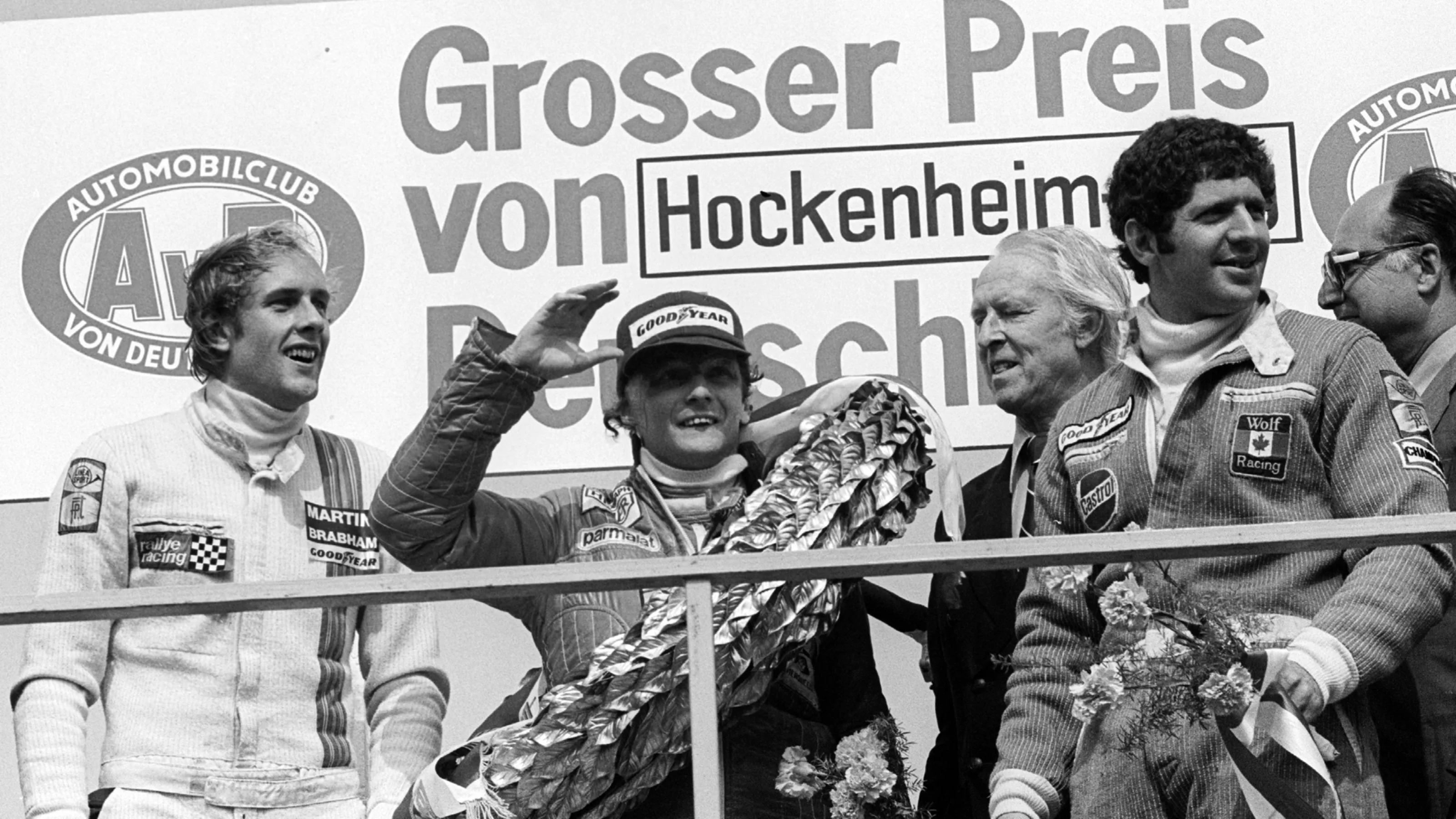 The podium (L to R): Hans-Joachim Stuck (GER) Brabham, third; Niki Lauda (AUT) Ferrari, race