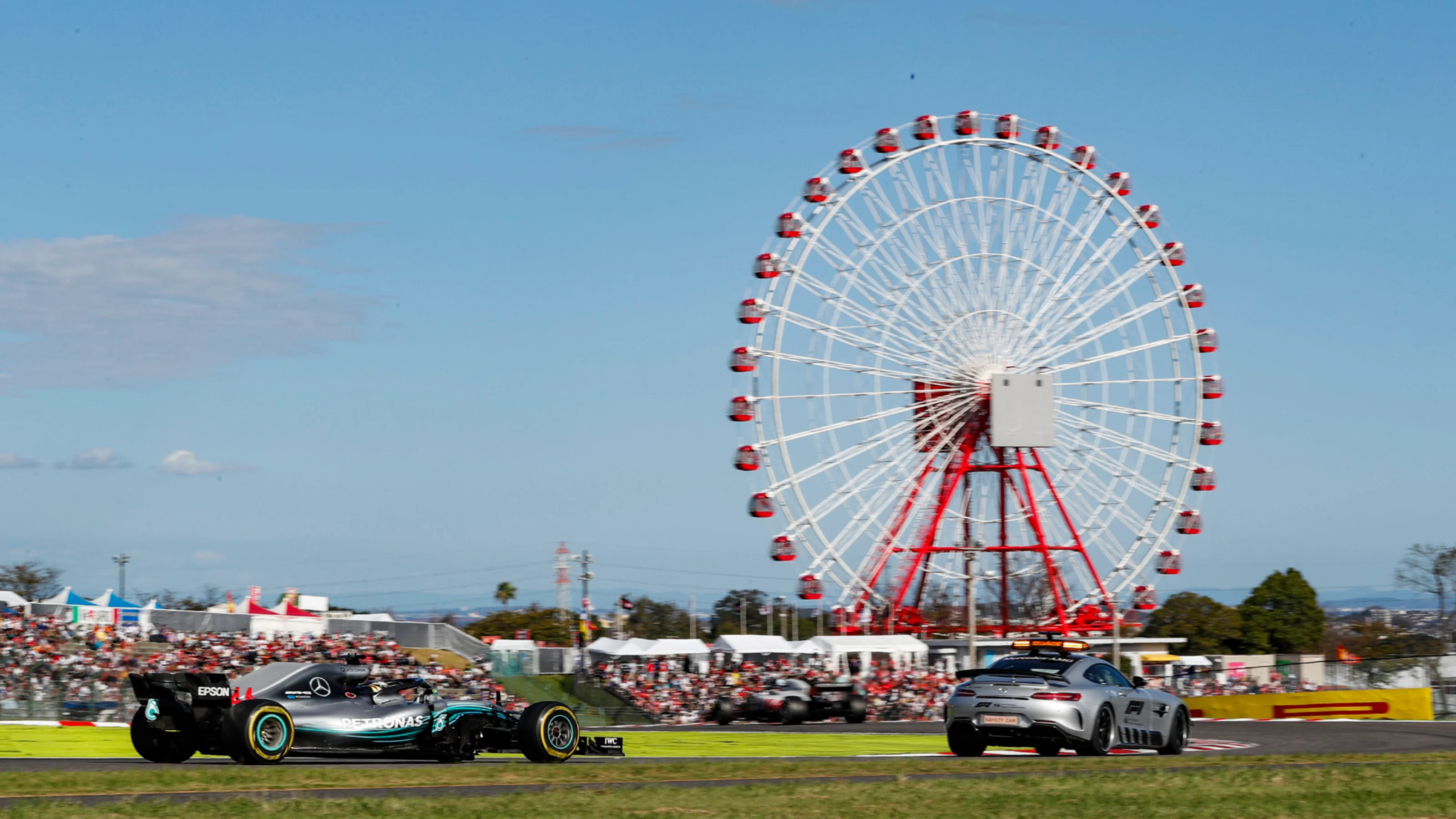 SUZUKA, JAPAN - OCTOBER 07: The Safety Car leads Lewis Hamilton, Mercedes AMG F1 W09 EQ Power+