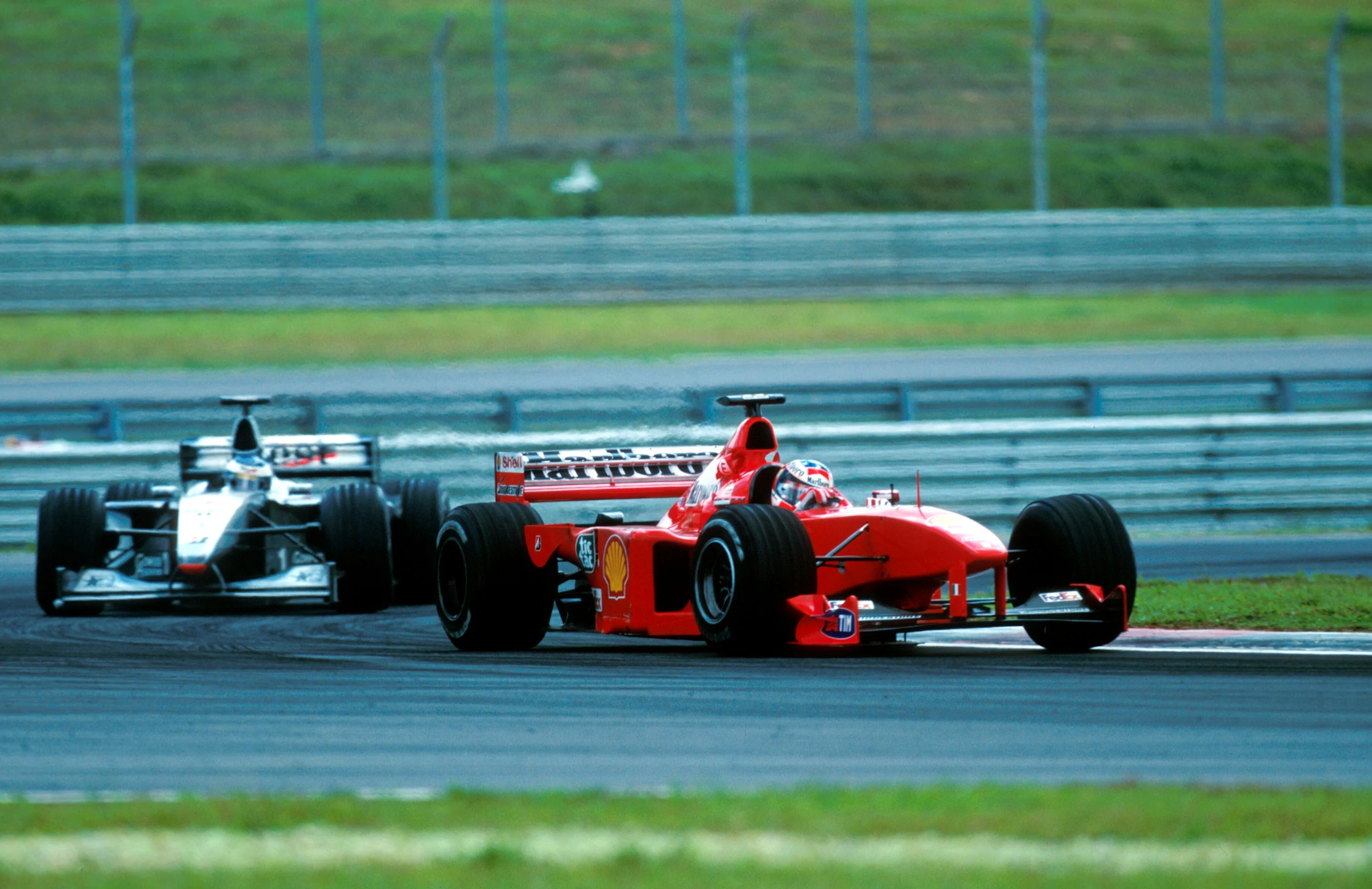 Michael Schumacher(GER) Ferrari F399 leads Hakkinen  Malaysian GP, Sepang, 17 October 1999
