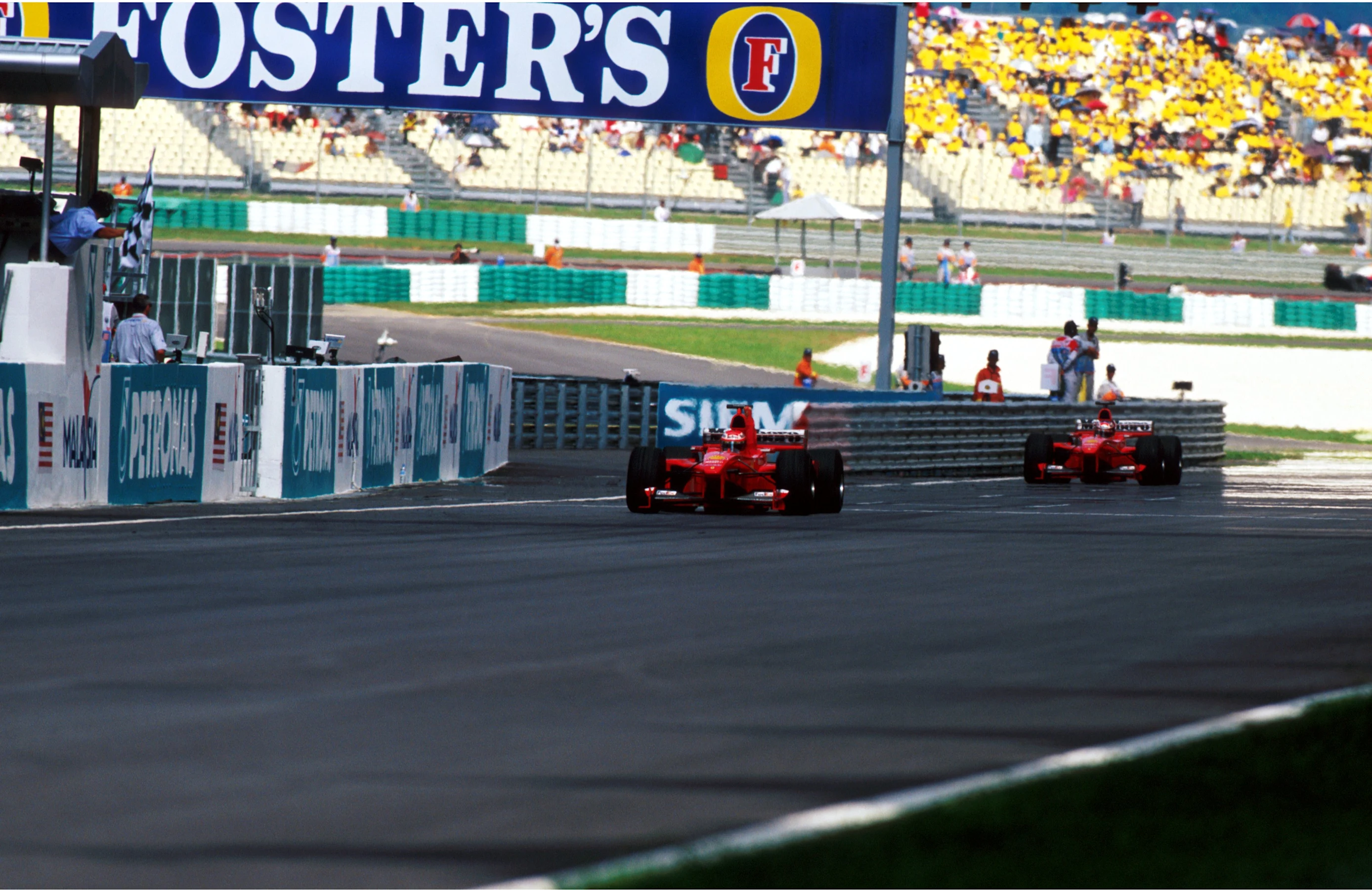 Eddie Irvine (GBR) Ferrari F399 took a victory aided by second placed team mate Michael Schumacher