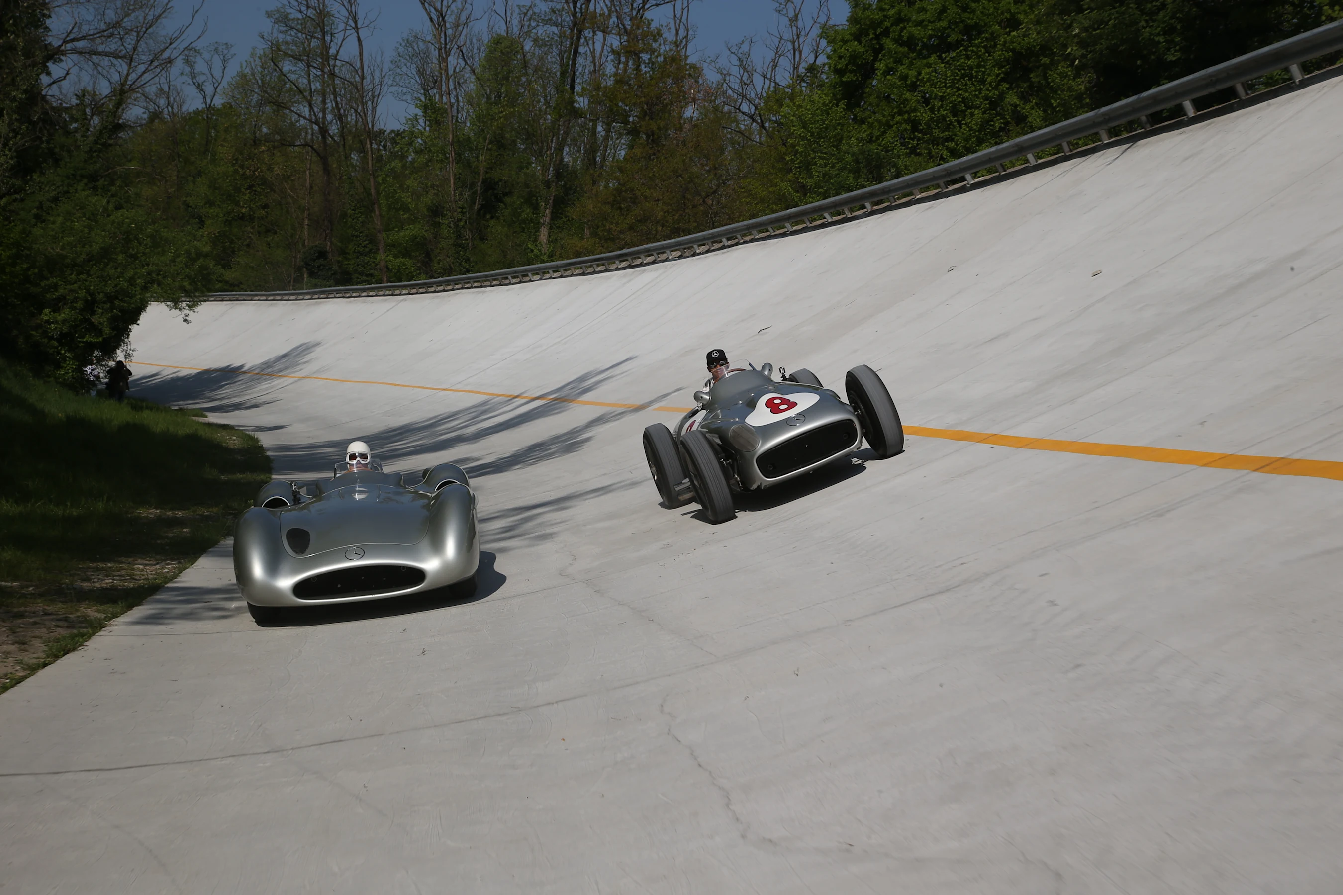 Stirling Moss (left) and Lewis Hamilton (right) sample the Mercedes W196 - in streamliner and