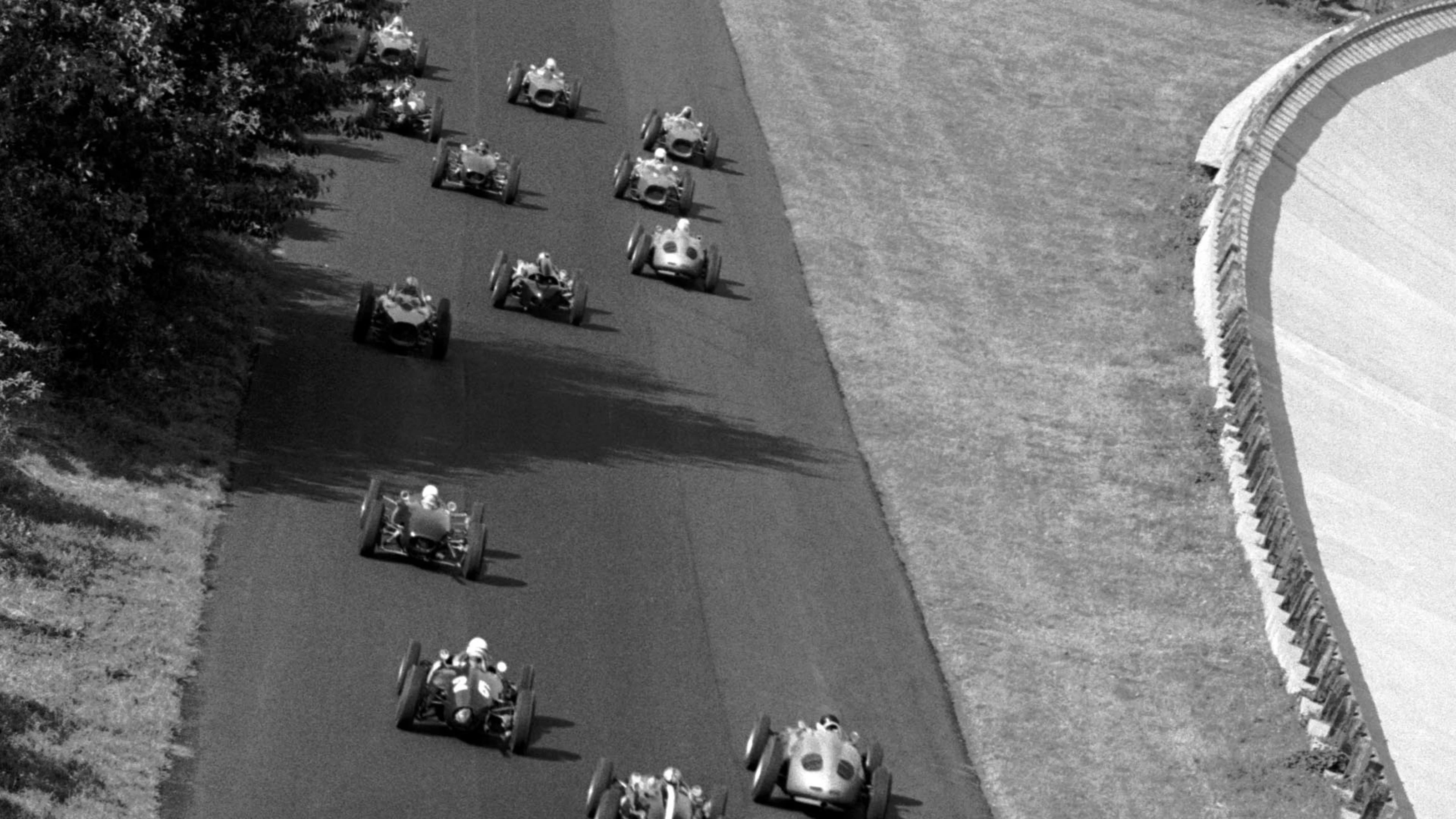 The field head towards the Curve Grande, with the circuit's banked section visible on the right.