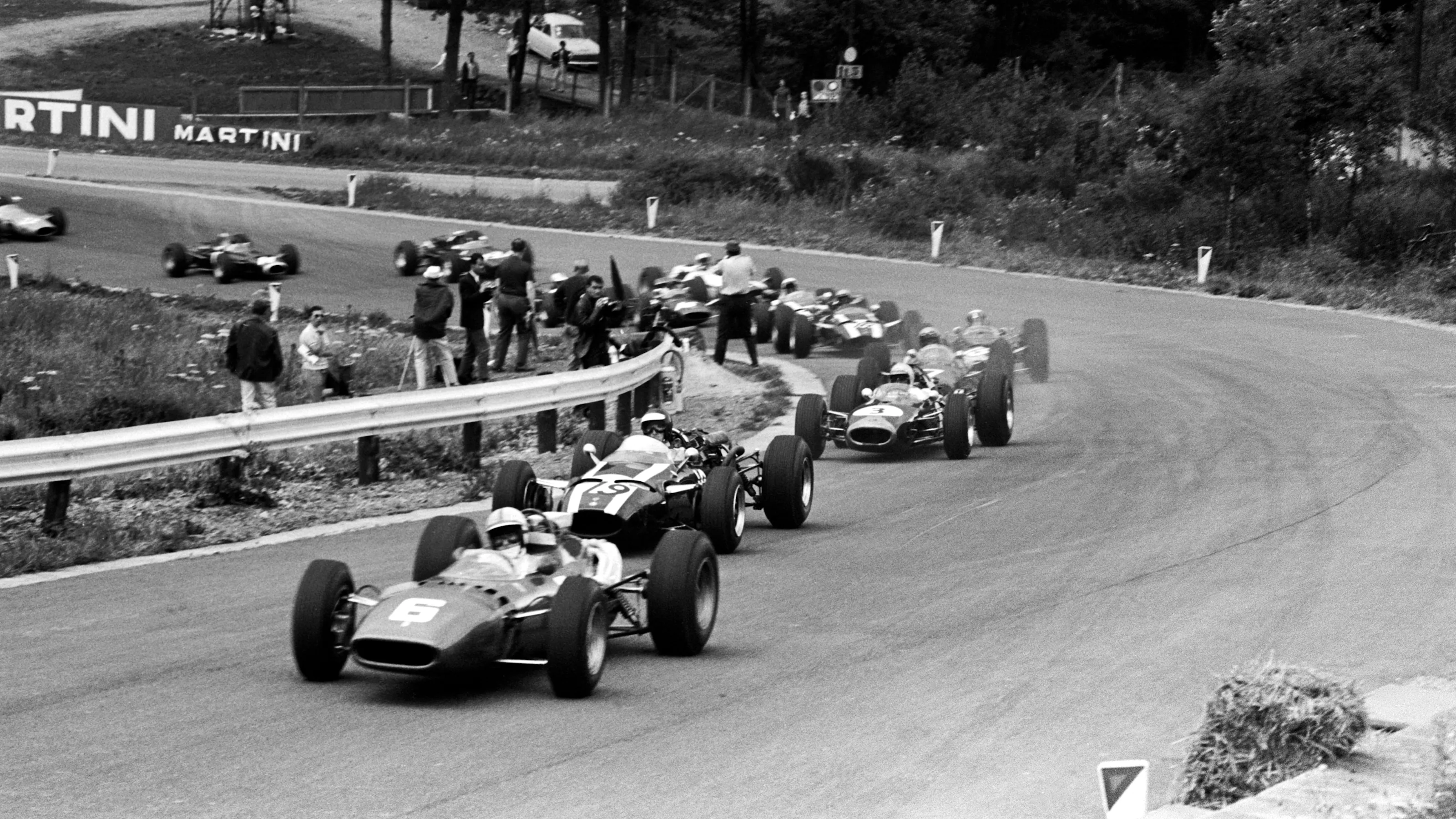 Pole sitter and race winner John Surtees (GBR) Ferrari 312 leads the field through Eau Rouge at the