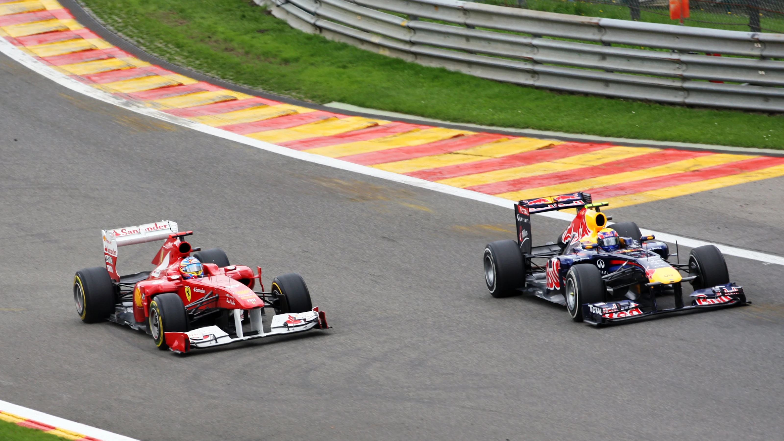 Fernando Alonso (ESP) Ferrari 150 Italia and Mark Webber (AUS) Red Bull Racing RB7.  Formula One
