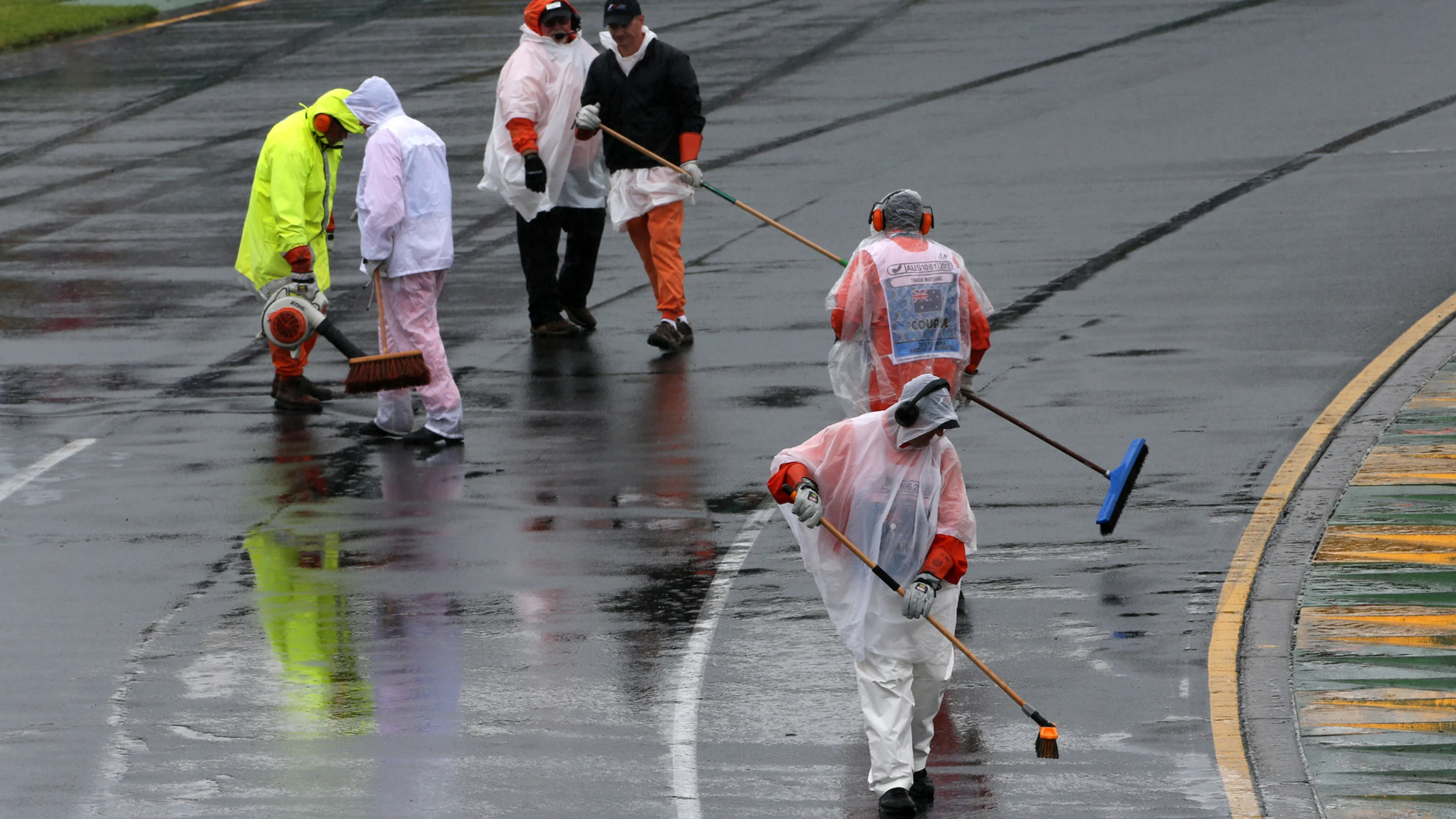 Marshals sweep water off of the track. Formula One World Championship, Rd1, Australian Grand Prix,