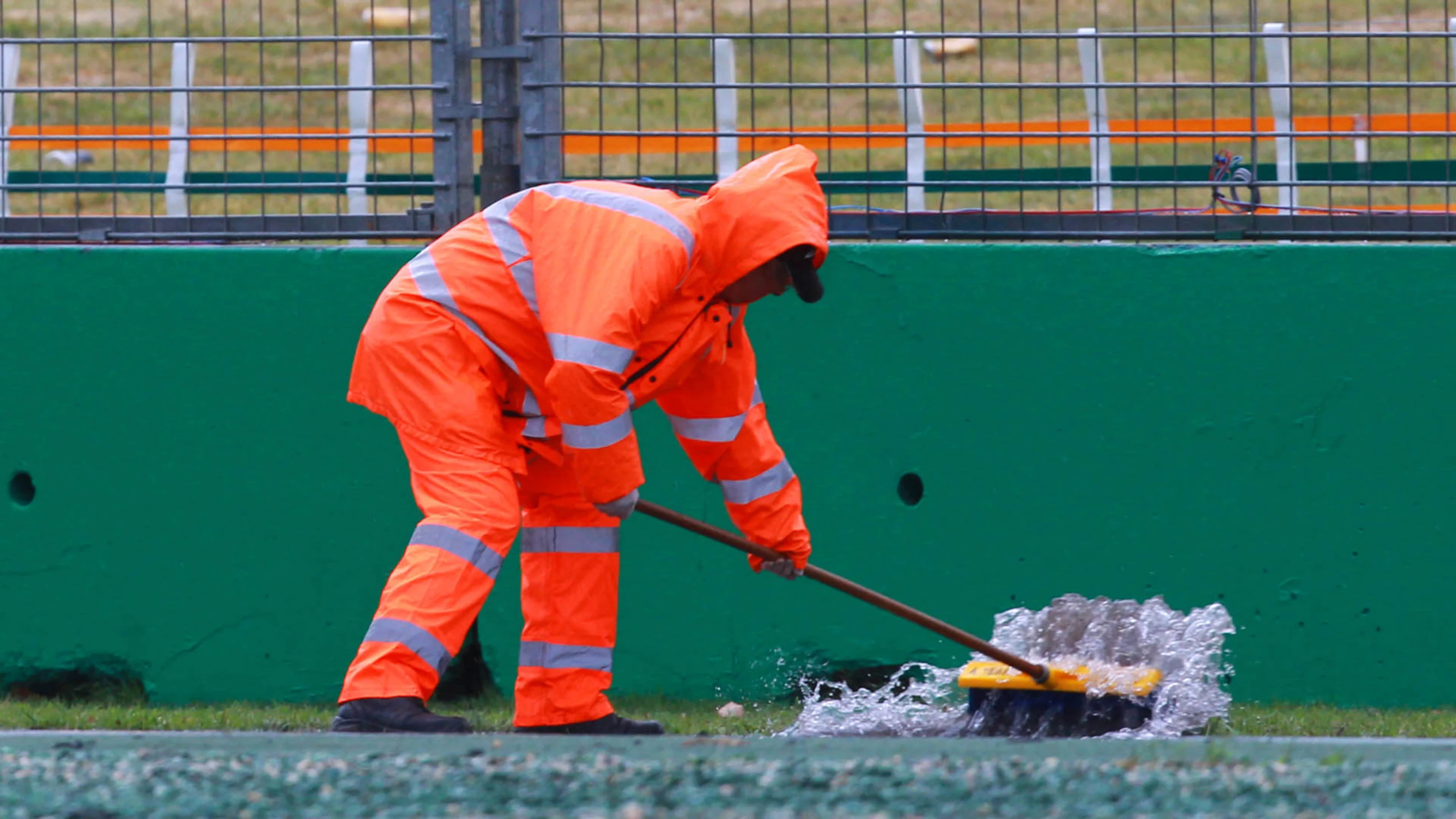 Marshal sweeps water from the track. Formula One World Championship, Rd1, Australian Grand Prix,