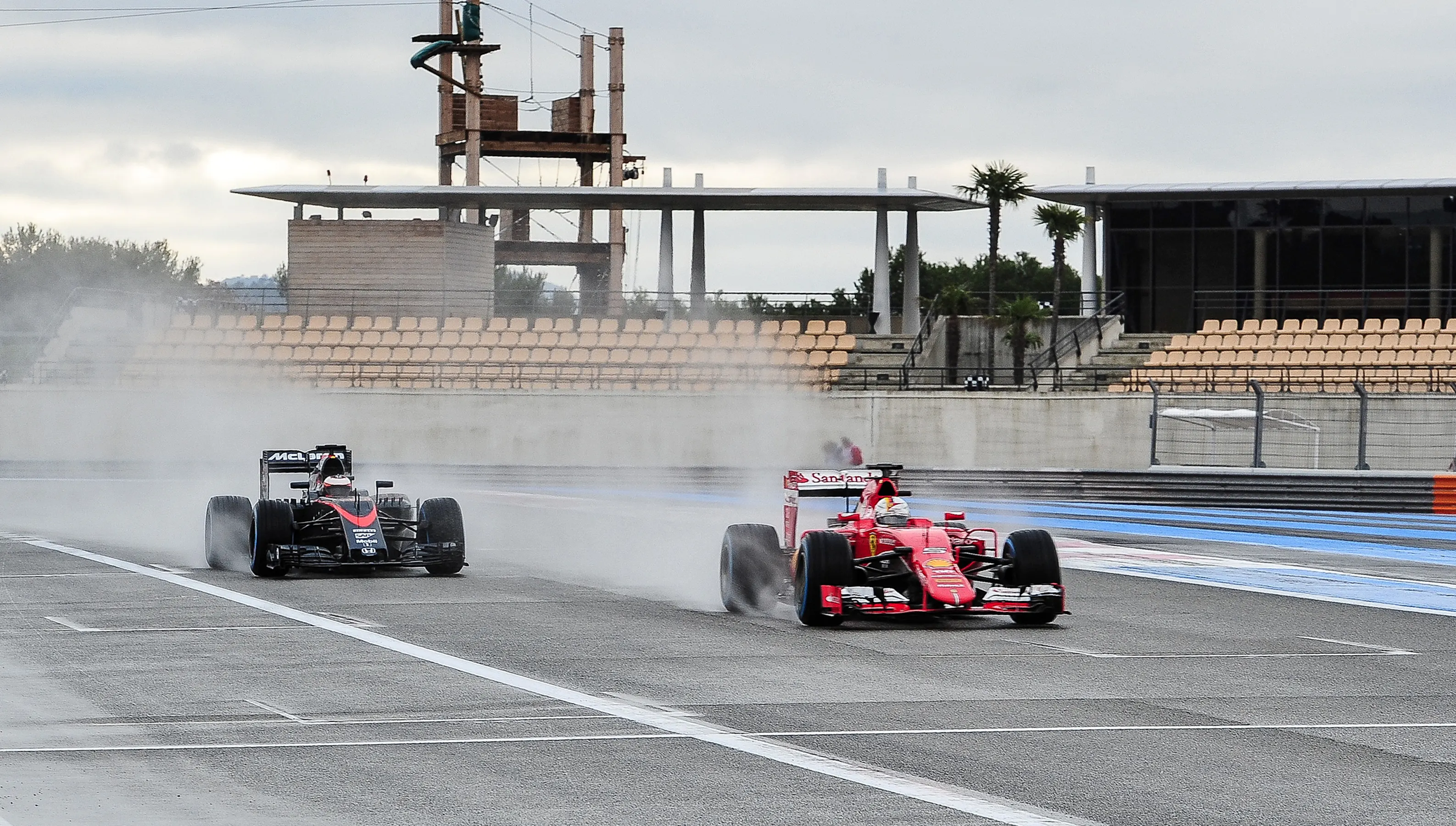 Sebastian Vettel (GER) Ferrari SF15-T leads Stoffel Vandoorne (BEL) McLaren MP4-30 at Pirelli