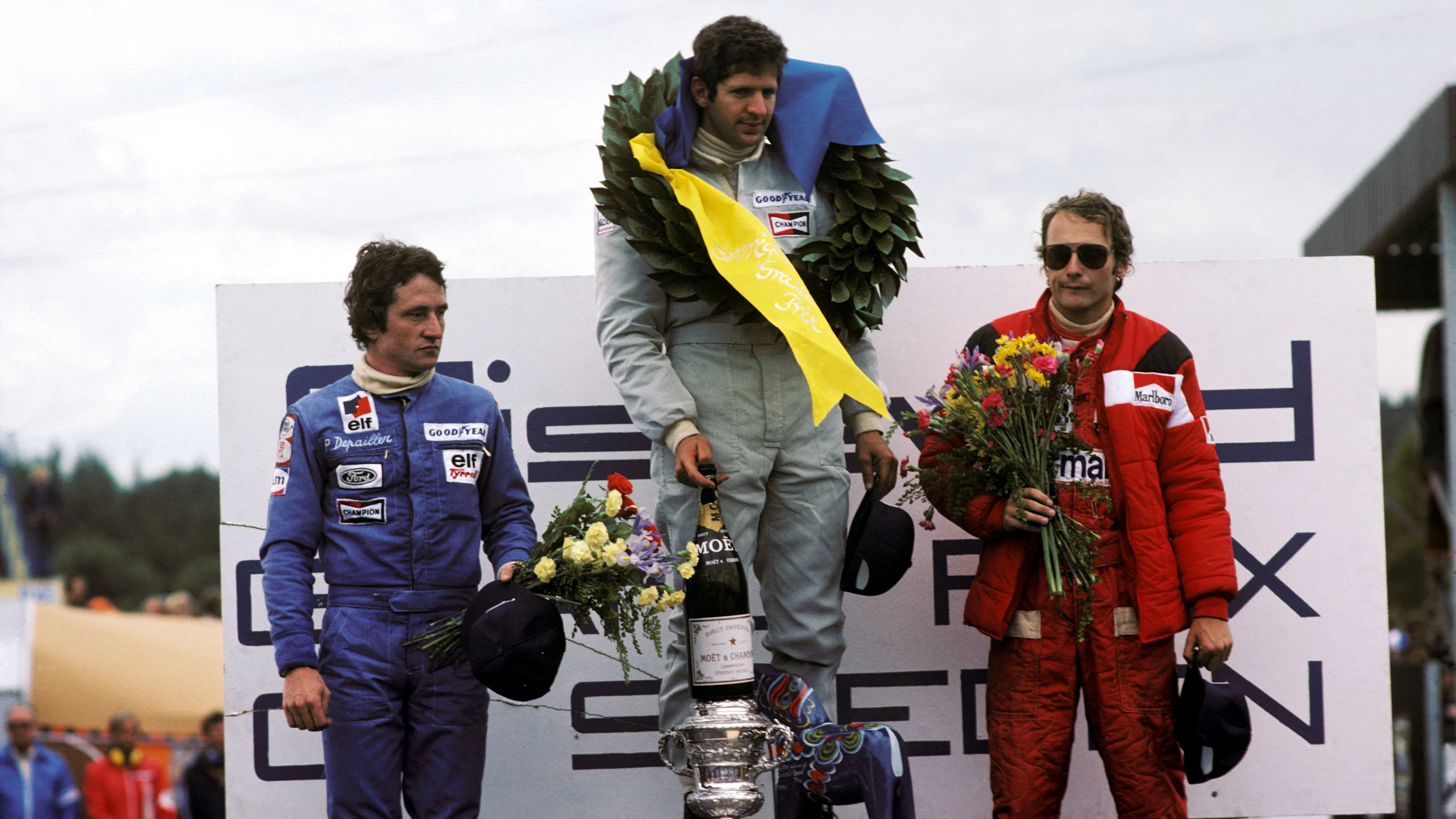 The podium (L to R): Patrick Depailler (FRA) Tyrrell, second; Jody Scheckter (RSA) Tyrrell, winner;