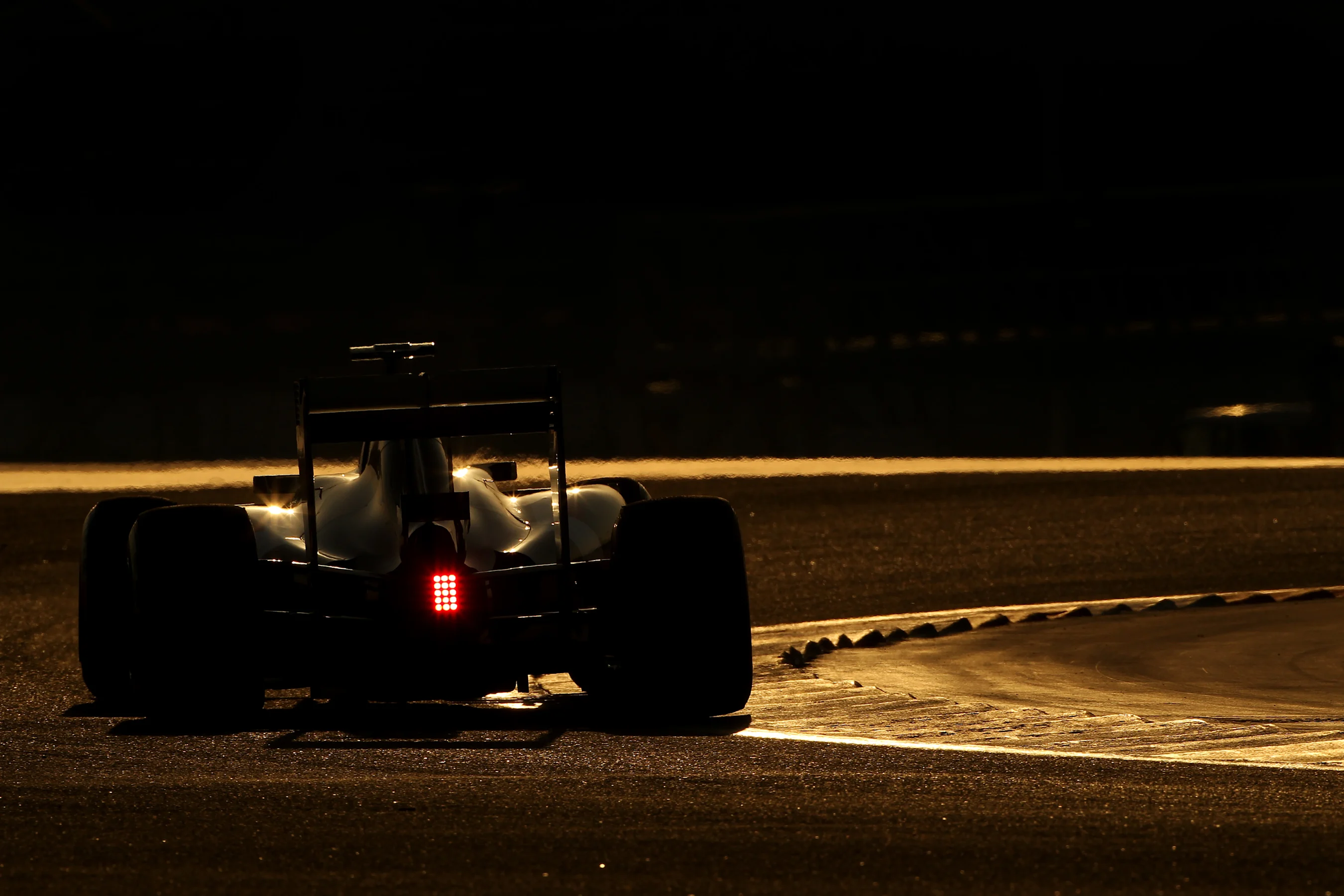 Action at sunset, Formula One Testing, Day One, Bahrain International Circuit, Sakhir, Bahrain,