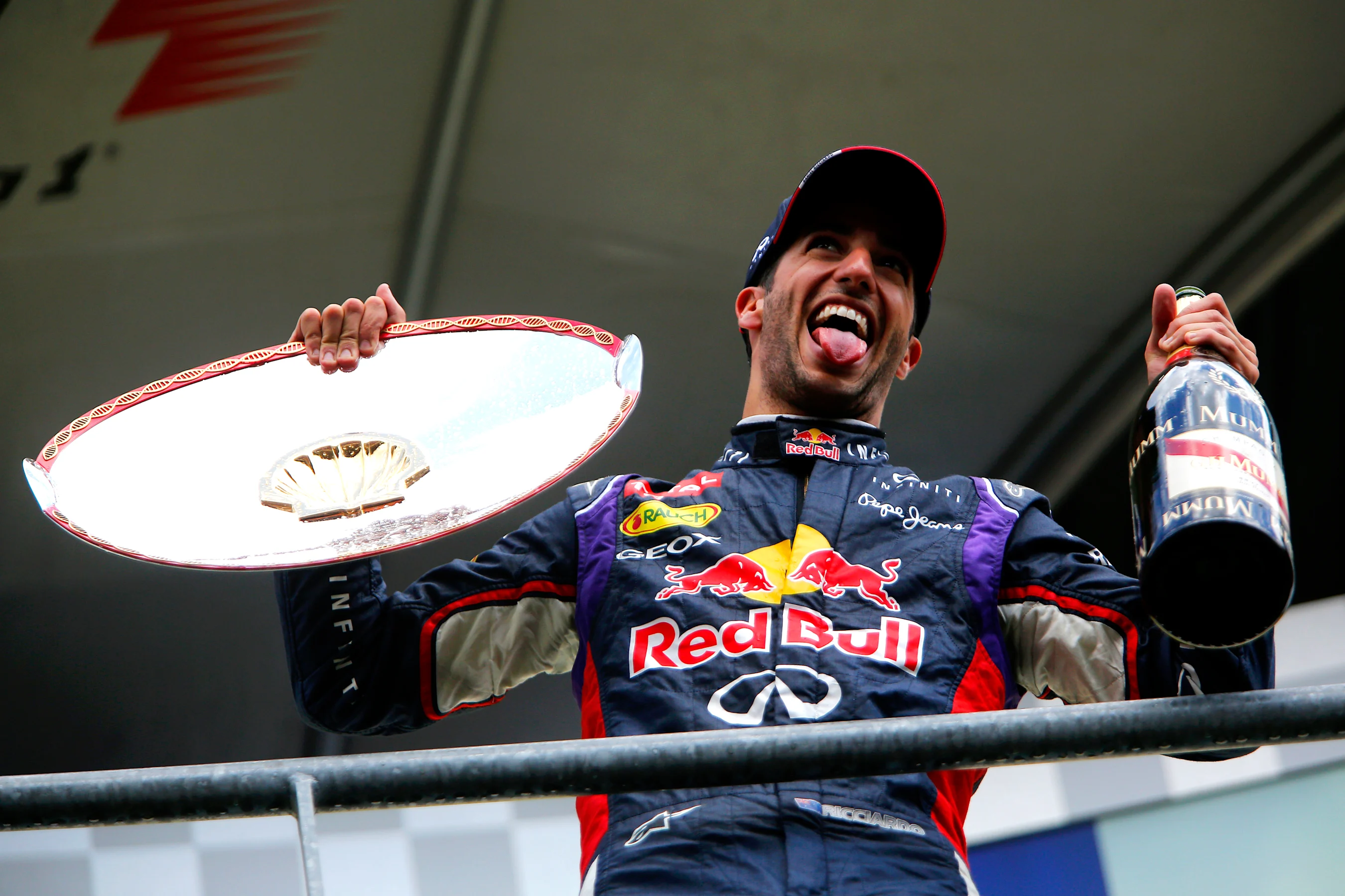 Race winner Daniel Ricciardo (AUS) Red Bull Racing with his trophy and champagne on the podium.