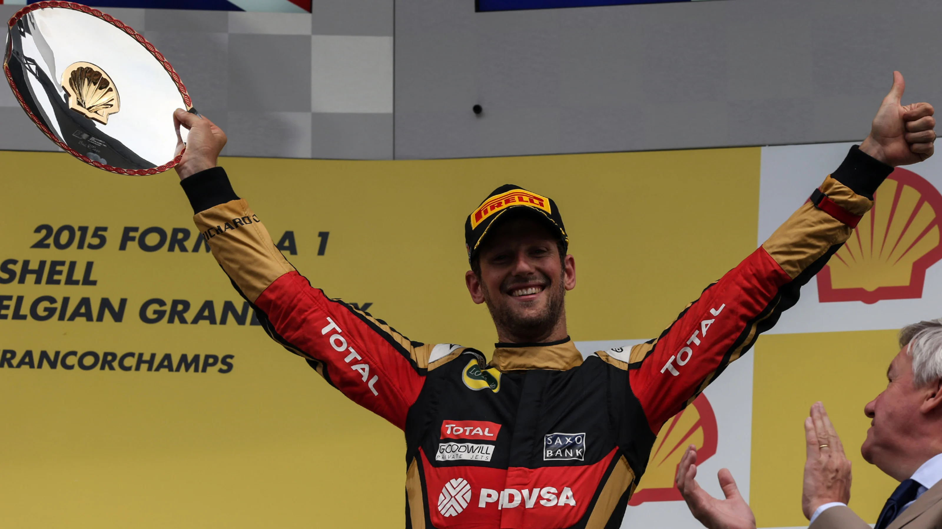 Romain Grosjean (FRA) Lotus F1 celebrates with the trophy on the podium at Formula One World