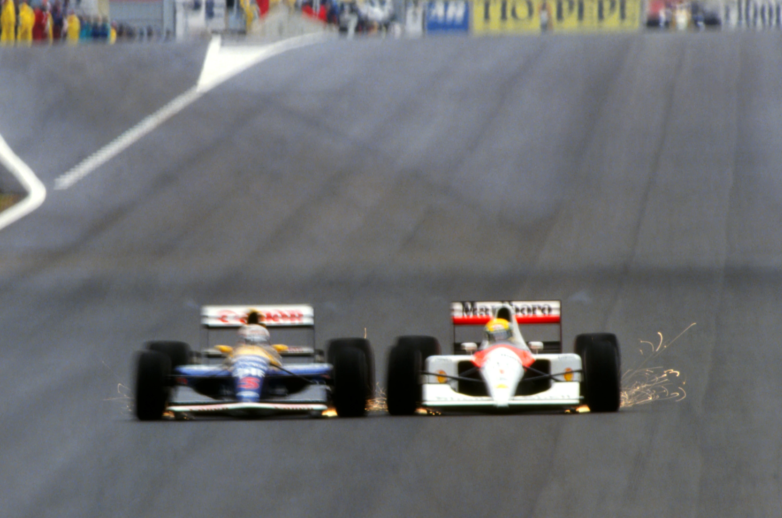 Race winner Nigel Mansell (GBR) Williams FW14 (left) and Ayrton Senna (BRA) McLaren MP4/6 drive