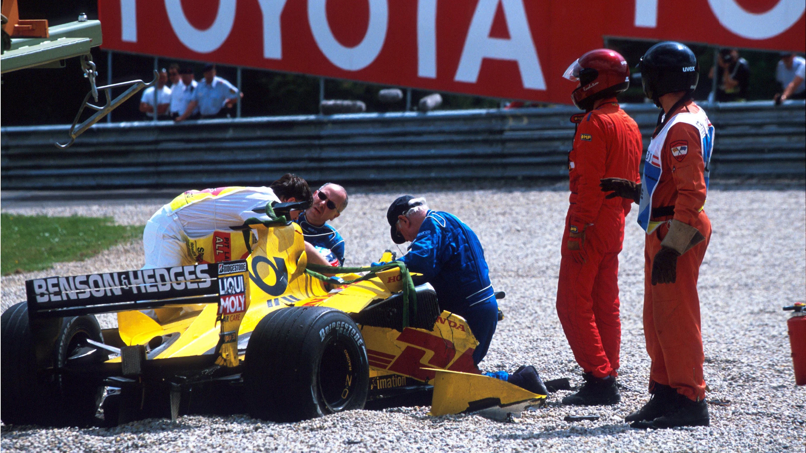 Professor Sid Watkins (GBR), right of cockpit tends to Takuma Sato (JPN) who has just made