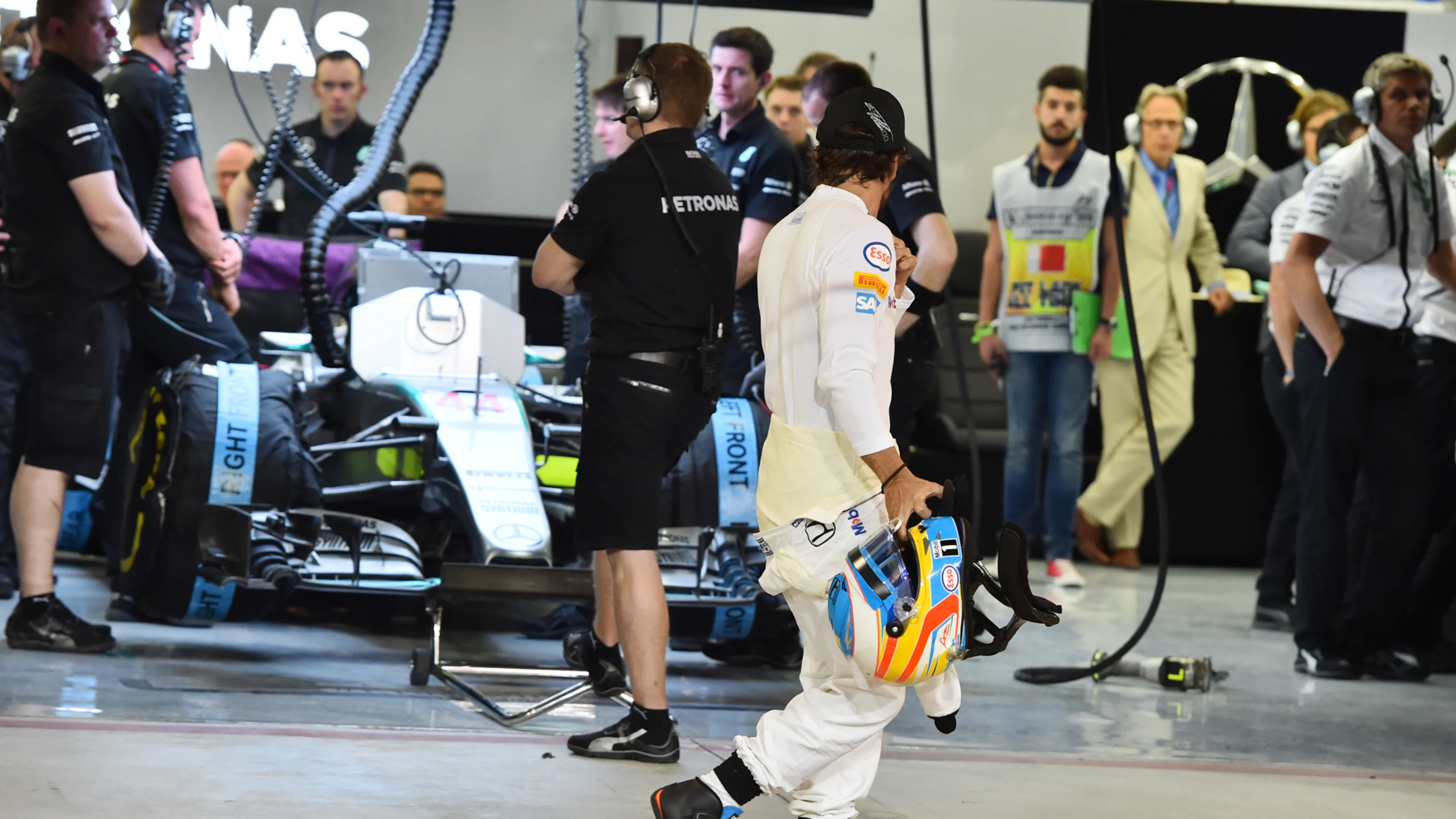 Fernando Alonso (ESP) McLaren walks past the Mercedes AMG F1 pit after Q1 at Formula One World