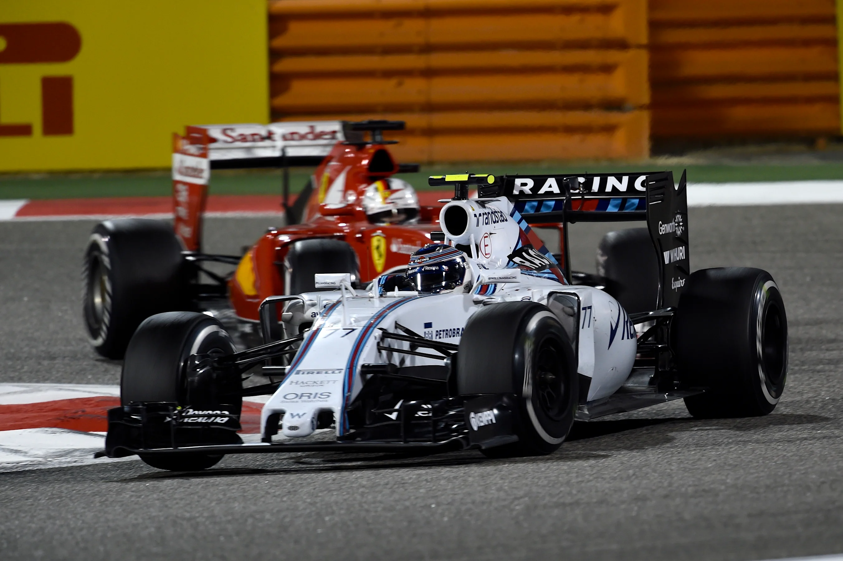 Valtteri Bottas (FIN) Williams FW37 and Sebastian Vettel (GER) Ferrari SF15-T at Formula One World
