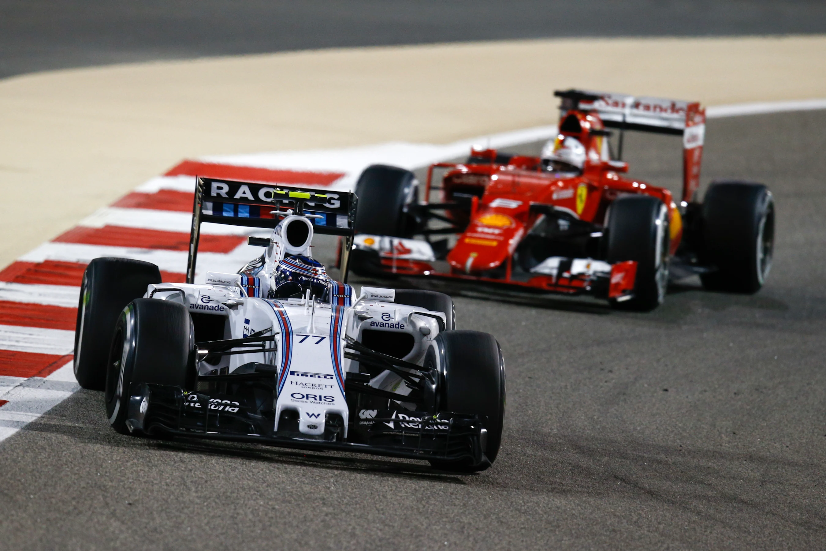 Valtteri Bottas (FIN) Williams FW37 and Sebastian Vettel (GER) Ferrari SF15-T at Formula One World