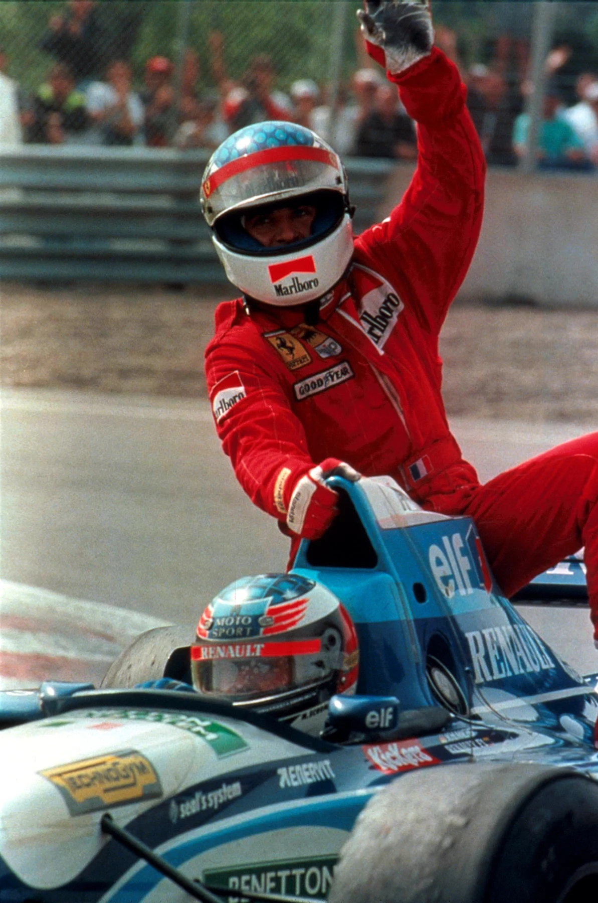 Jean Alesi (CDN) Ferrari celebrates his only victory in Formula One whilst being given a lift back