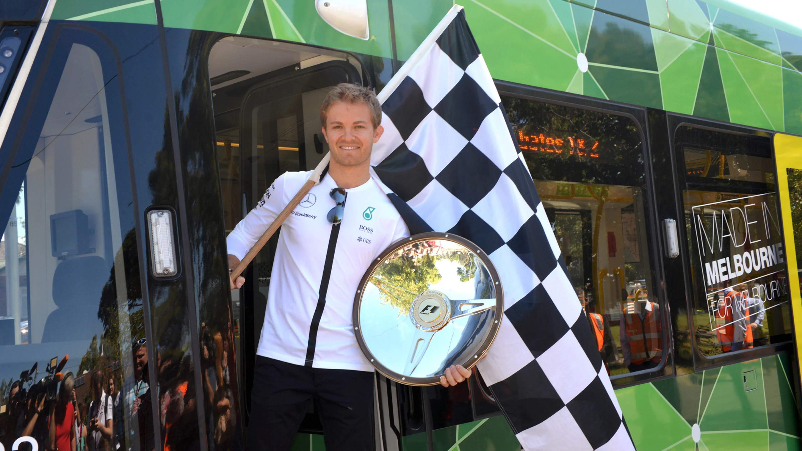 Nico Rosberg (GER) Mercedes AMG F1 with his 2014 Australian GP winners trophy aboard the Rosberg