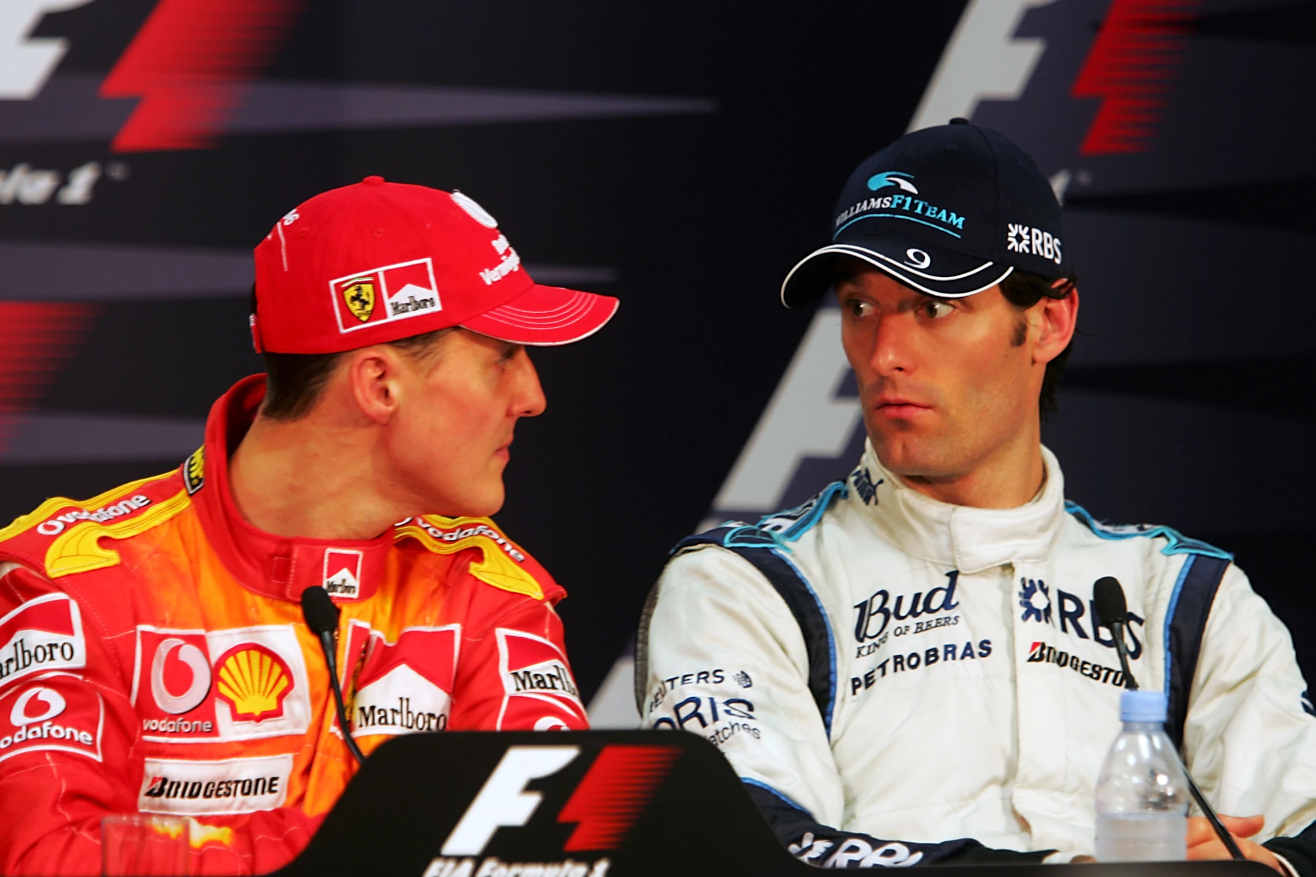 (L to R): Pole sitter Michael Schumacher (GER) Ferrari talks with Mark Webber (AUS) Williams in the