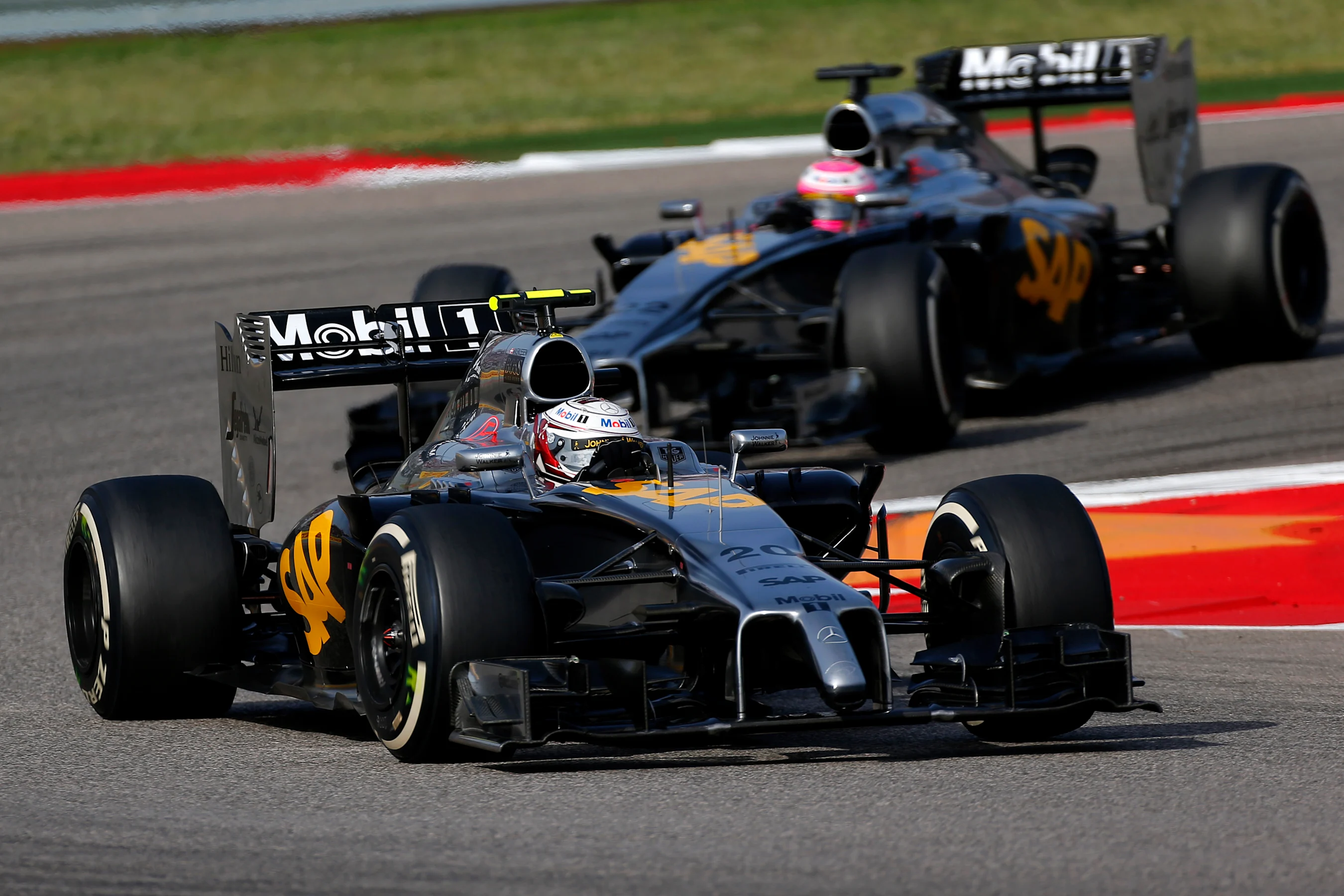 Kevin Magnussen (DEN) McLaren MP4-29 leads Jenson Button (GBR) McLaren MP4-29. Formula One World
