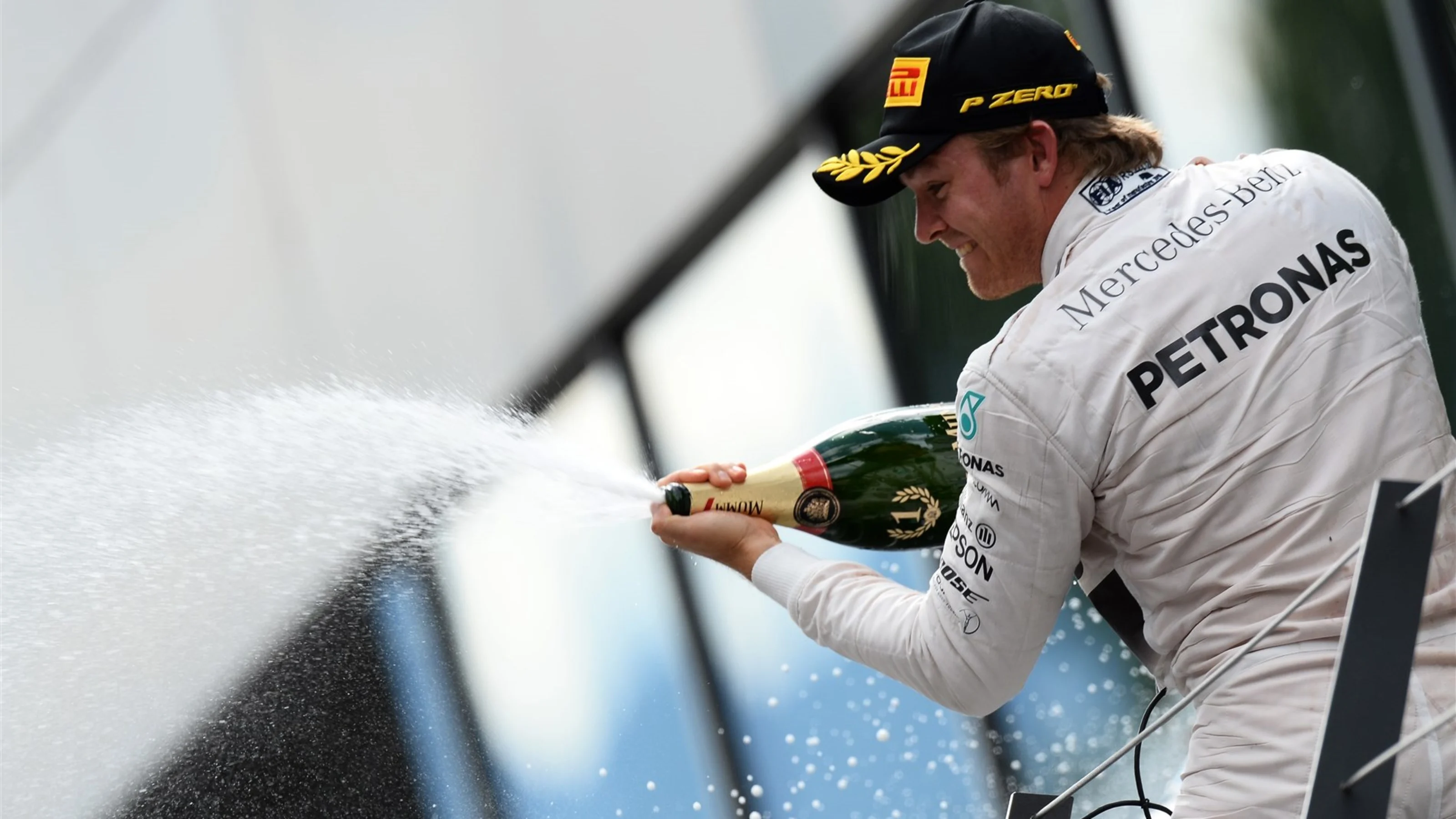 Race winner Nico Rosberg (GER) Mercedes AMG F1 celebrates in on the podium with the champagne at