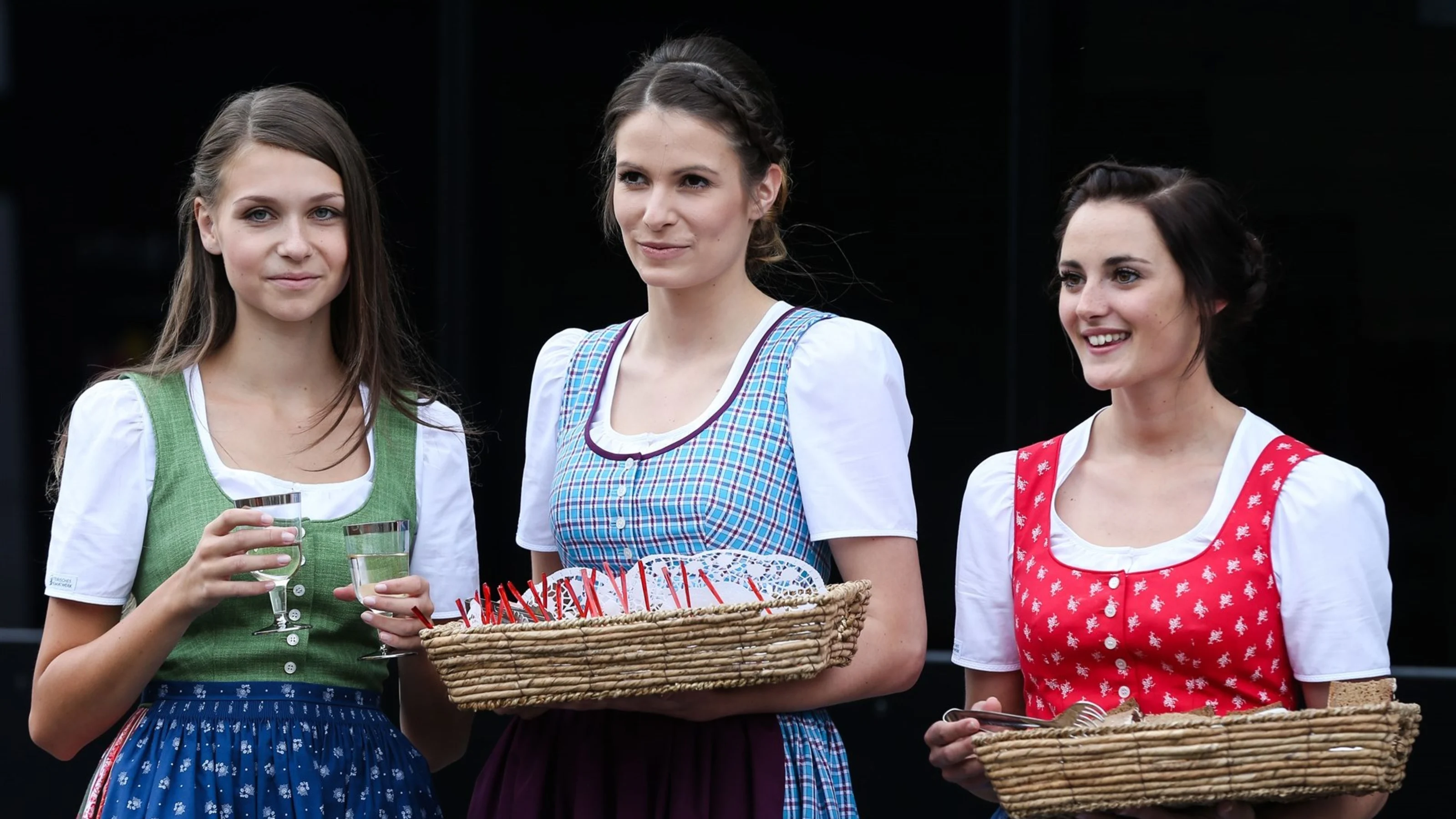 Formula Unas girls serving traditional food in the paddock at Formula One World Championship, Rd8,