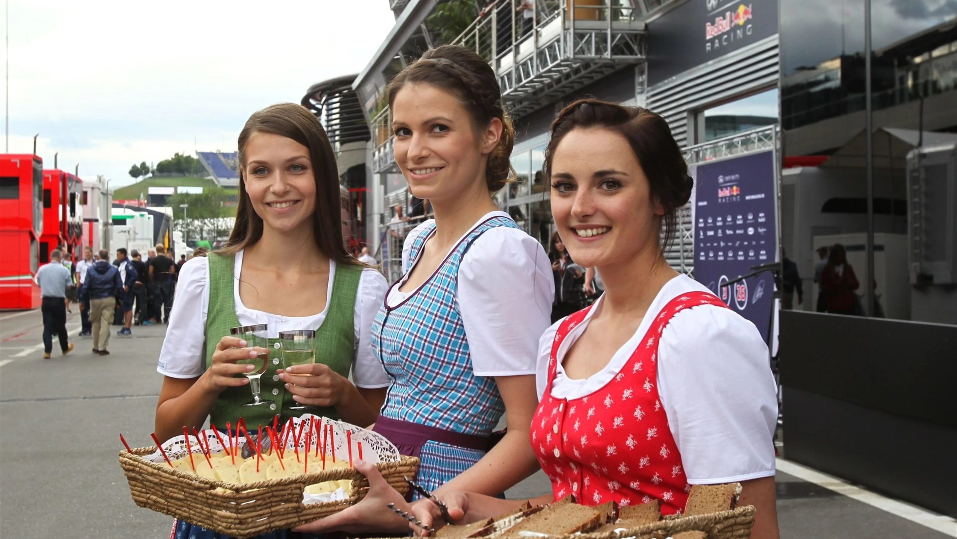 Austrian girls in traditional dress serving food in the paddock at Formula One World Championship,