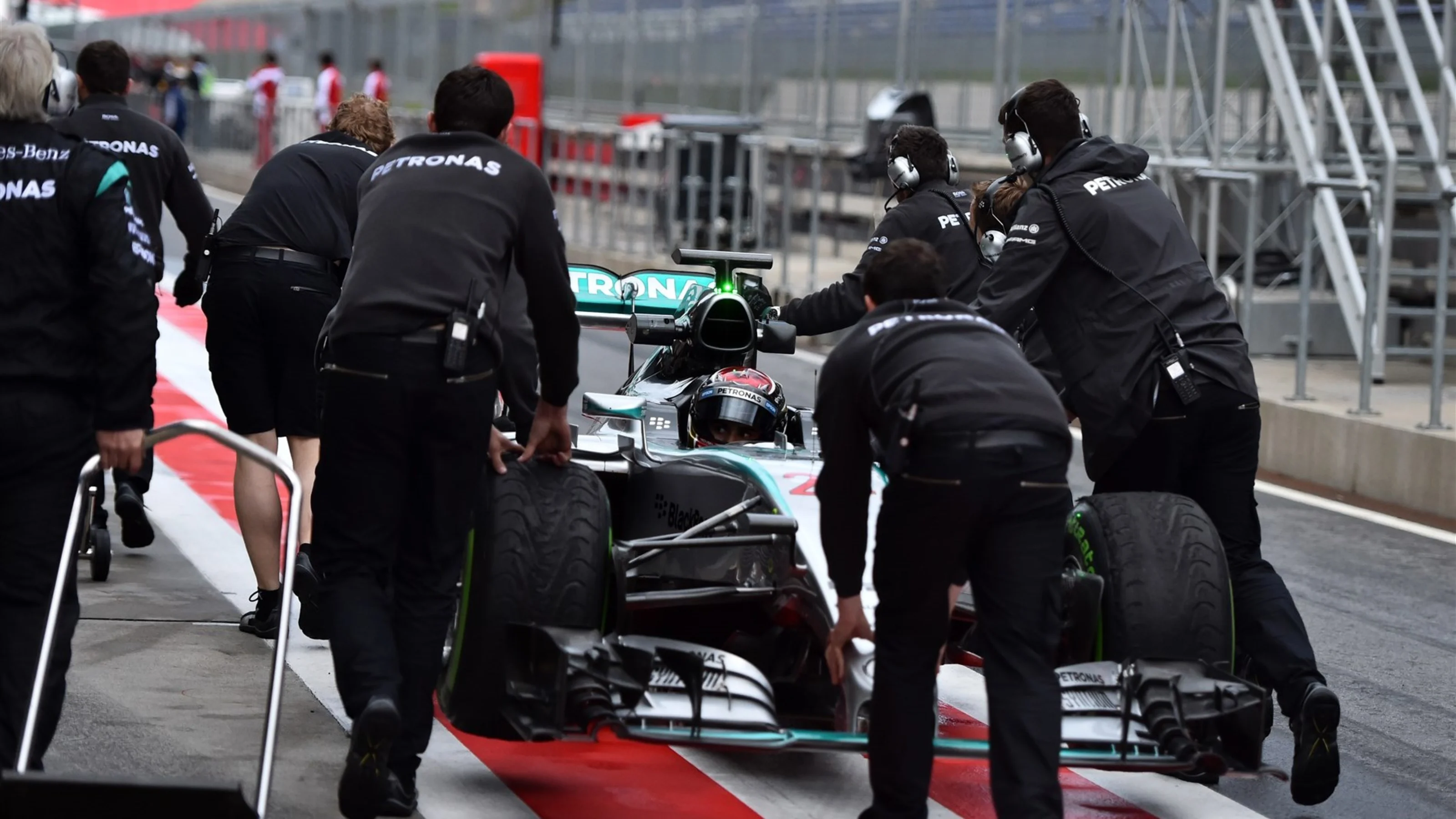 Pascal Wehrlein (GER) Mercedes AMG F1 W06 is pushed in pit lane by the Mercedes AMG F1 mechanics at