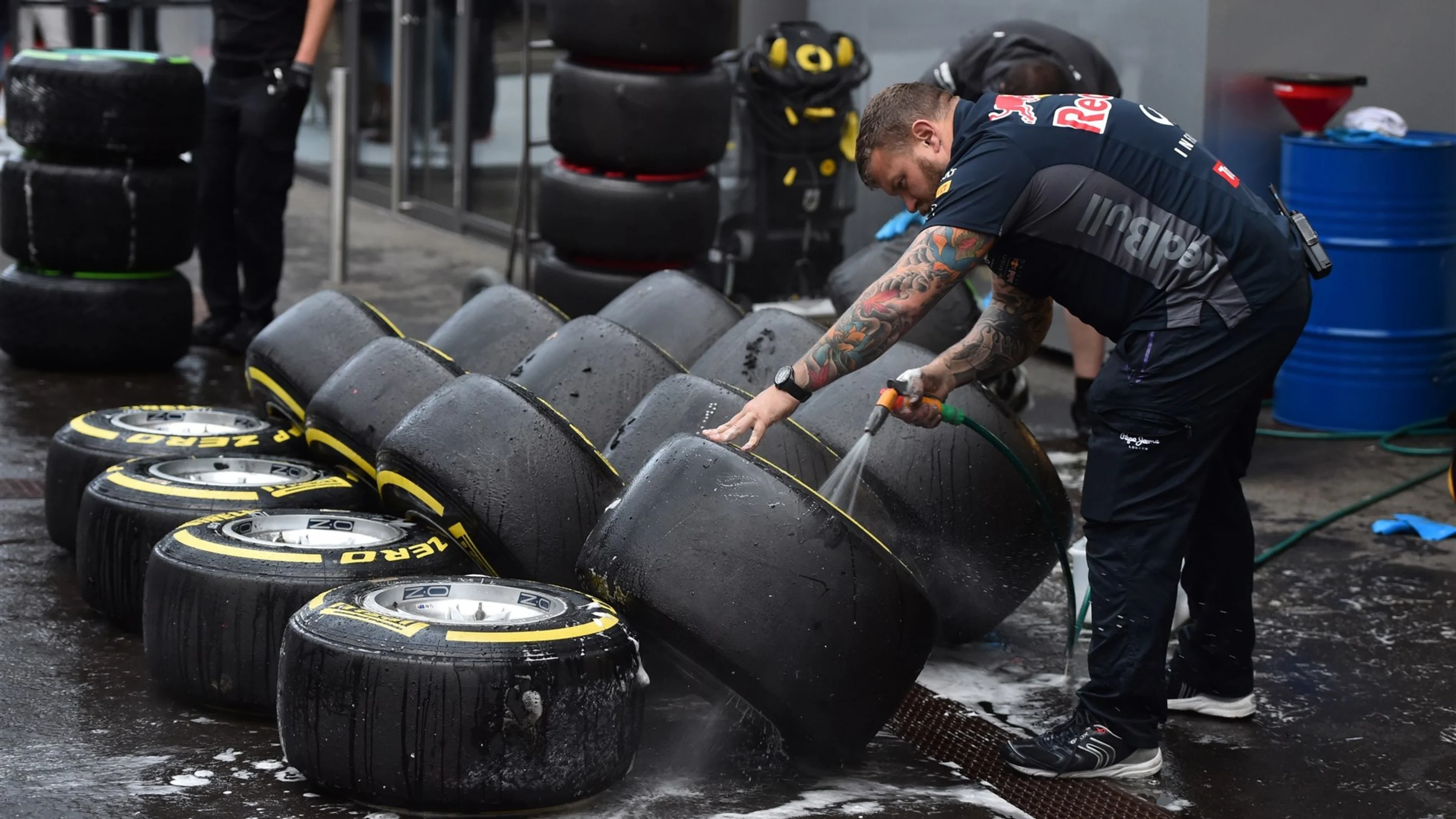 Red Bull Racing mechanic washes Pirelli tyres and wheels at Formula One Testing, Day One,