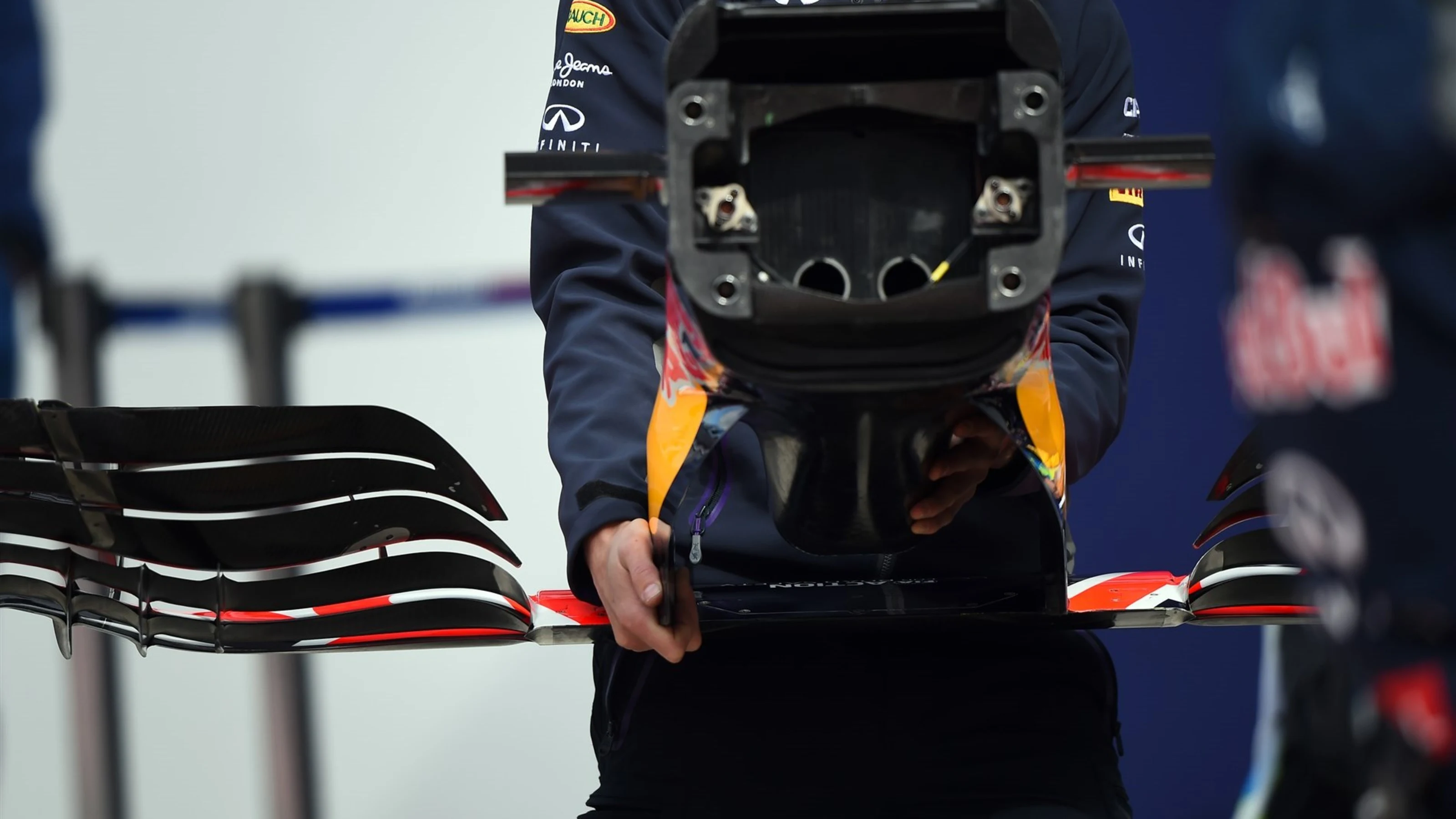 Mechanic carrying the nose and front wing of a Red Bull Racing RB11 at Formula One Testing, Day