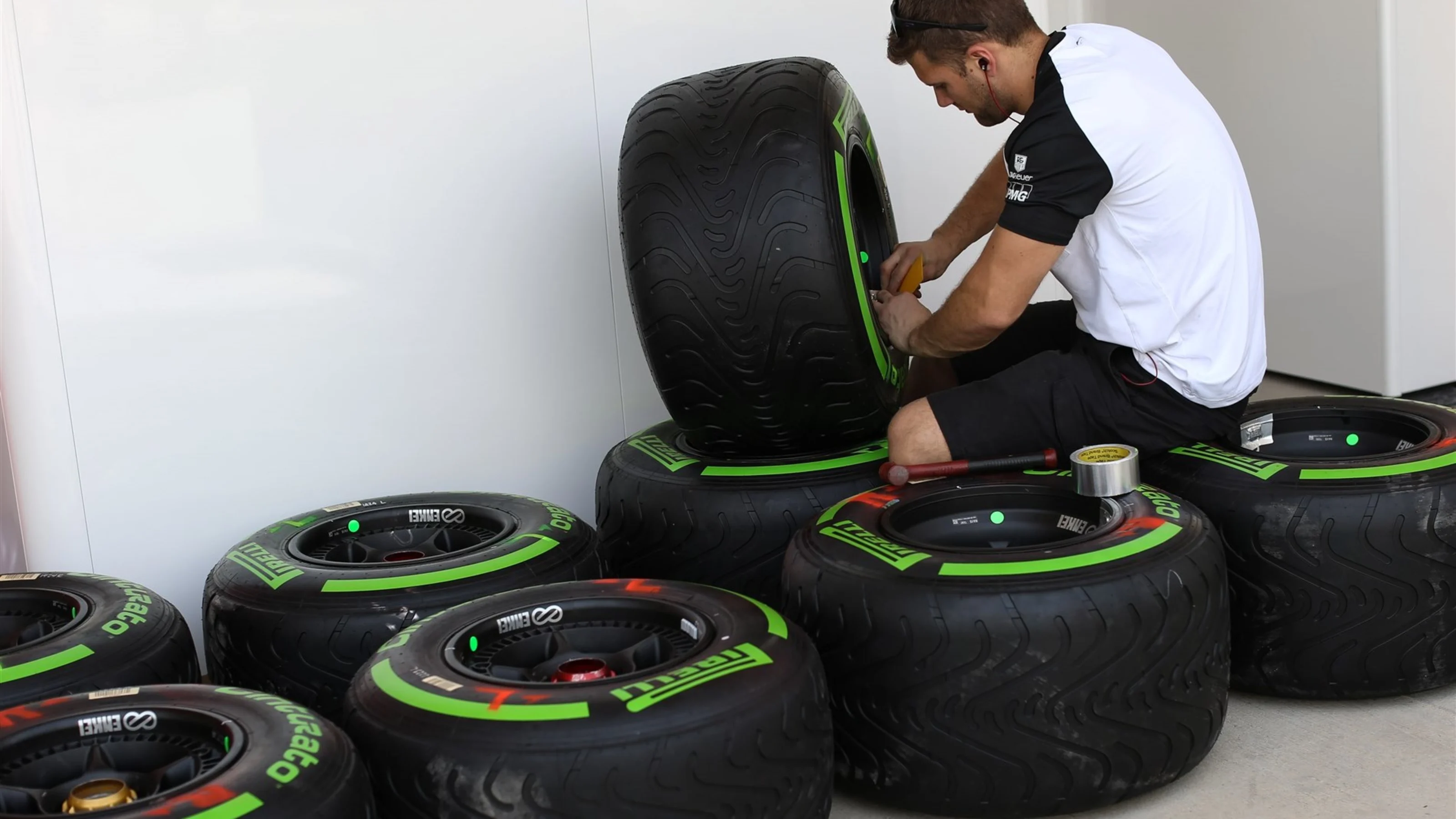 A McLaren machnic prepare a green colored intermediate Pirelli tyre at Formula One World