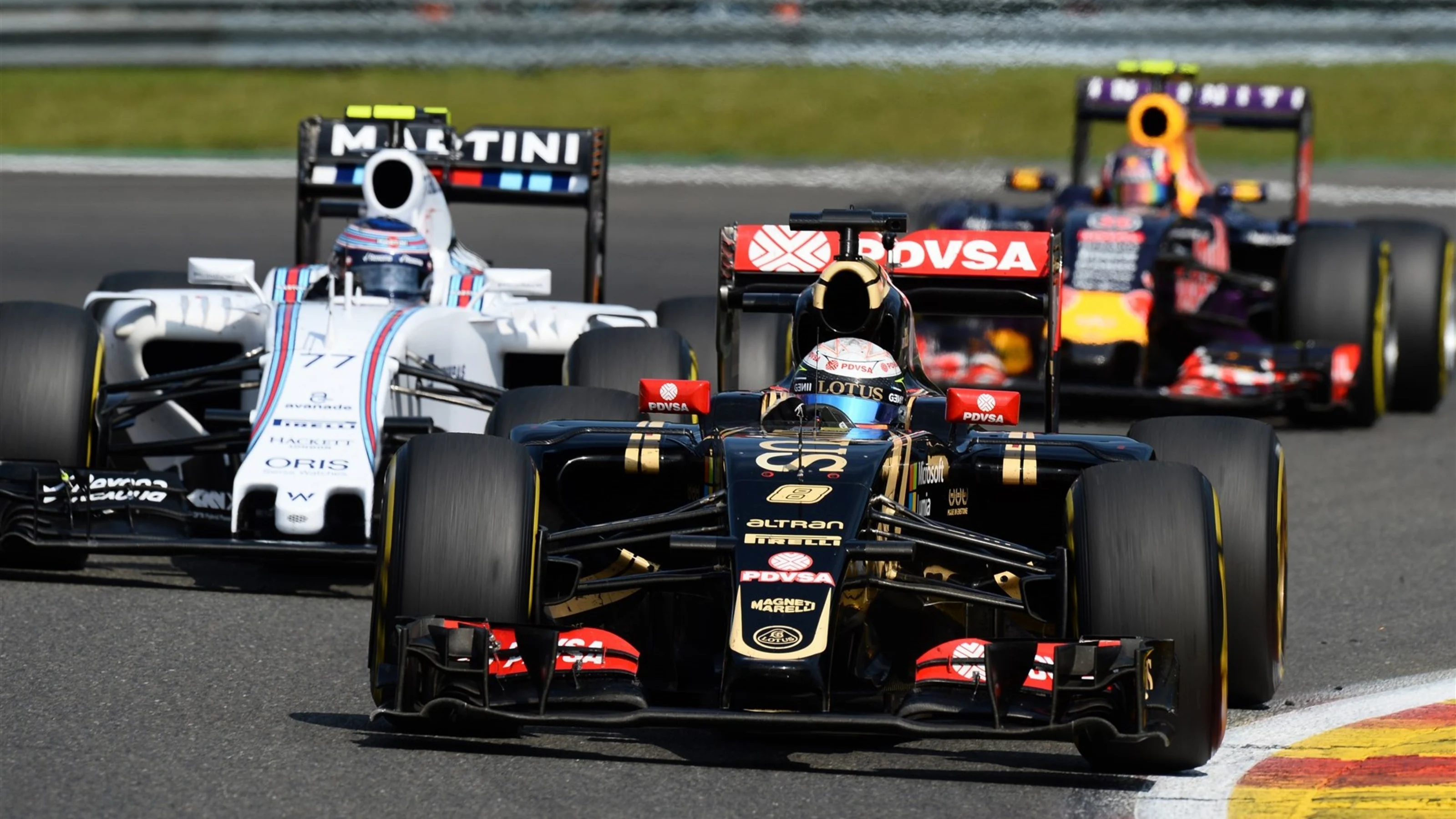 Romain Grosjean (FRA) Lotus E23 Hybrid battles with Valtteri Bottas (FIN) Williams FW37 at Formula