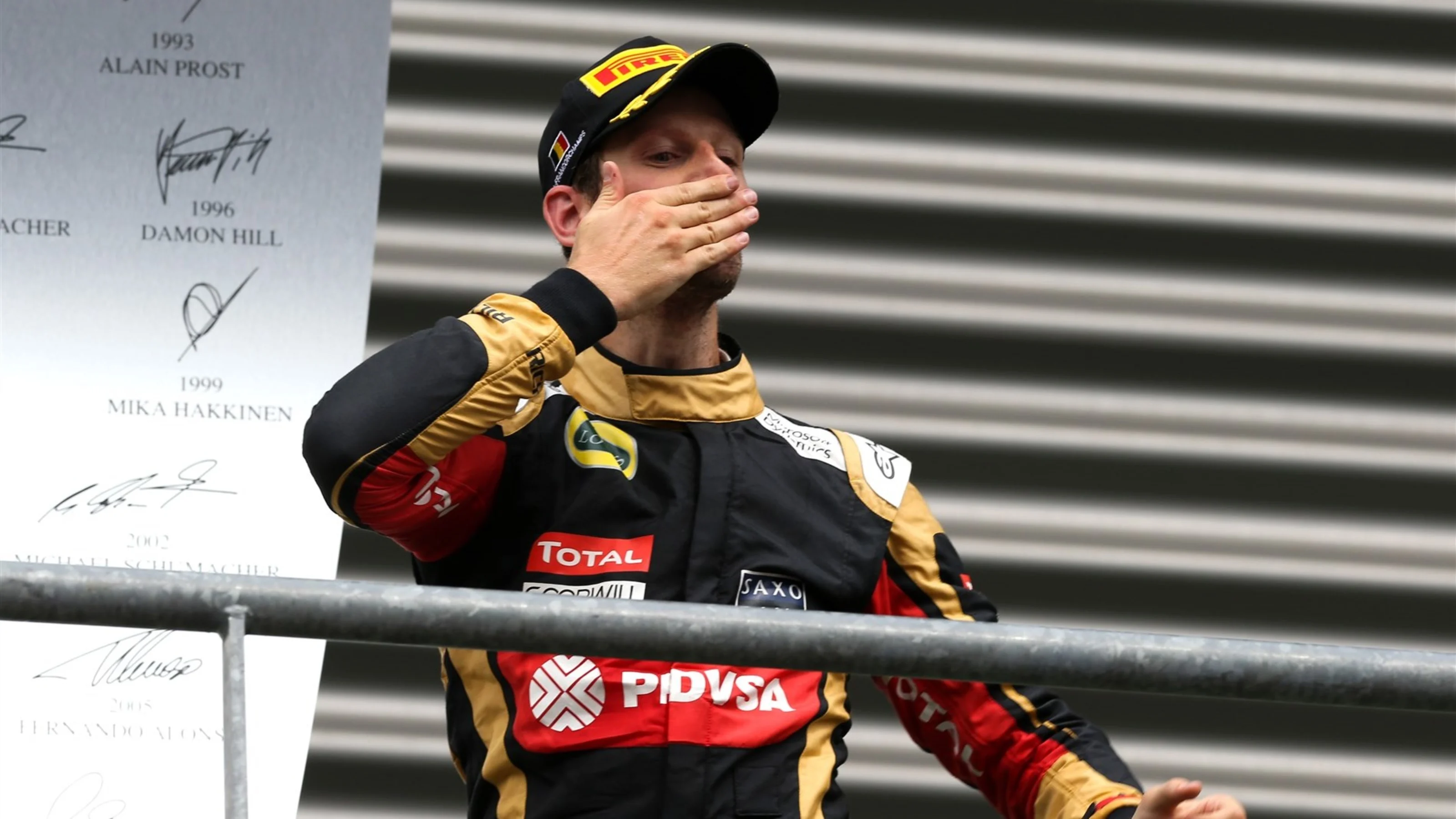 Romain Grosjean (FRA) Lotus F1 celebrates on the podium at Formula One World Championship, Rd11,