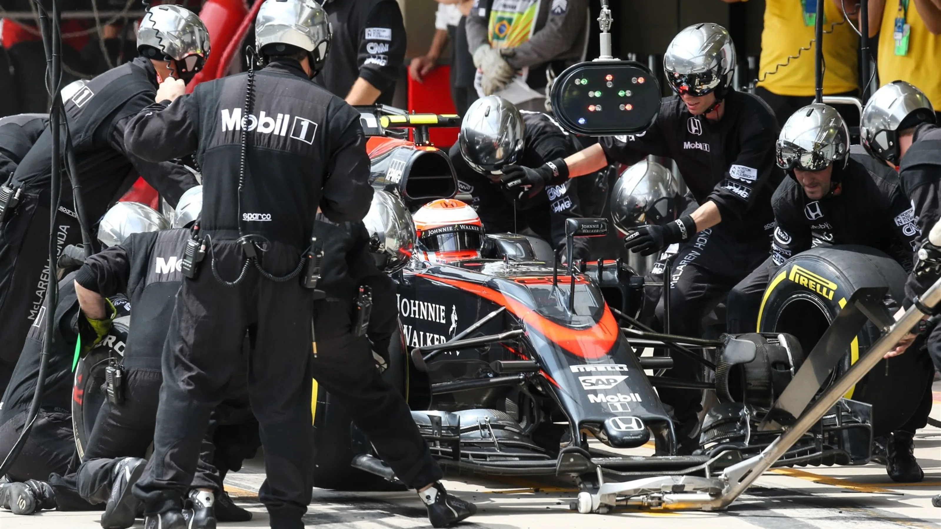 Jenson Button (GBR) McLaren MP4-30 pit stop at Formula One World Championship, Rd18, Brazilian