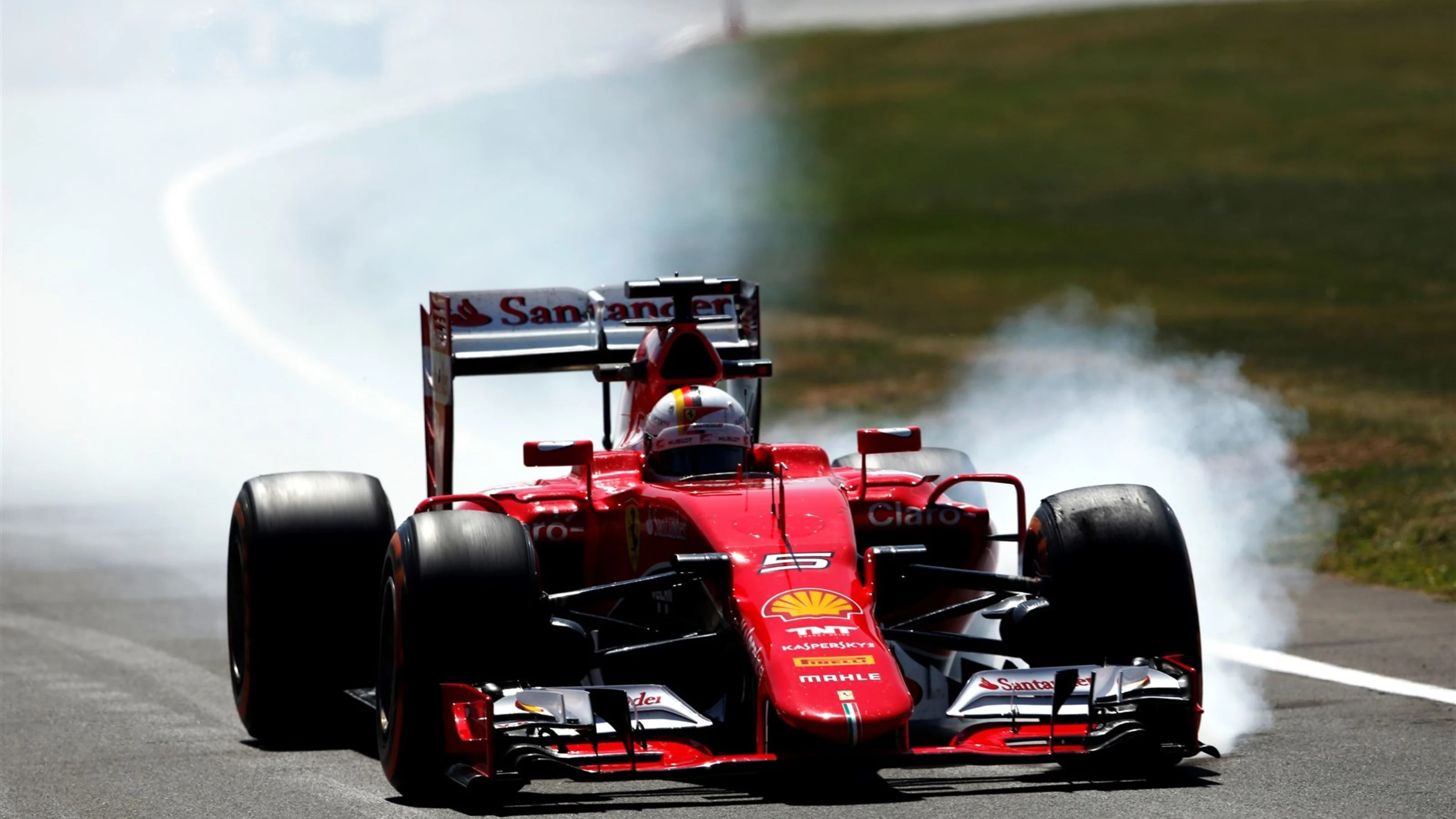 Sebastian Vettel (GER) Ferrari SF15-T locks up at Formula One World Championship, Rd9, British