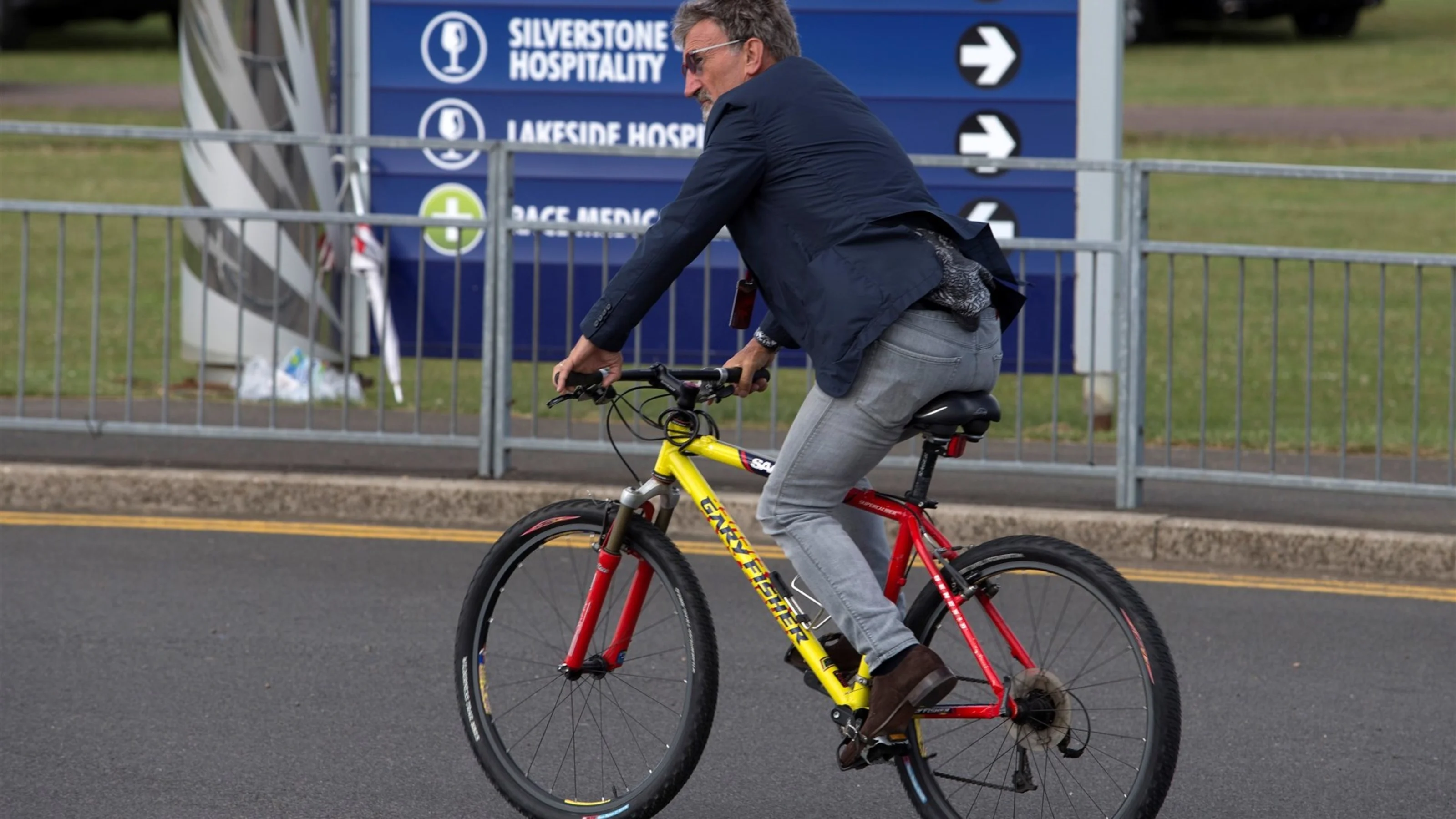 Eddie Jordan (IRE) BBC Television Pundit on a bike at Formula One World Championship, Rd9, British