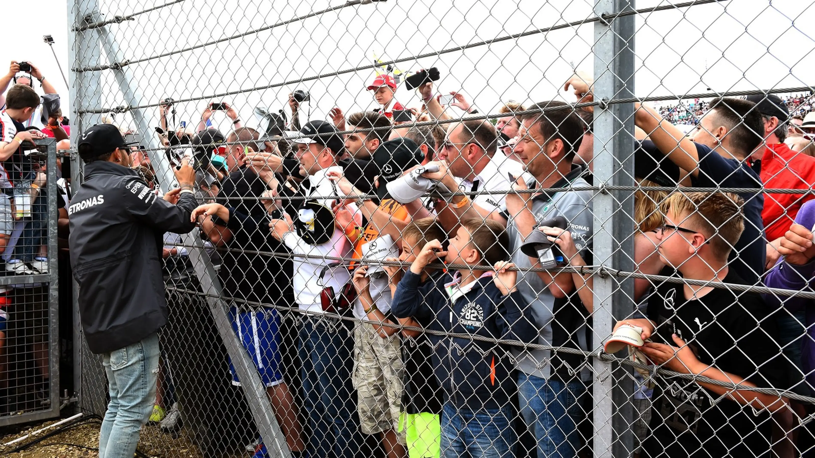 Lewis Hamilton (GBR) Mercedes AMG F1 signs autographs for the fans on the drivers parade at Formula