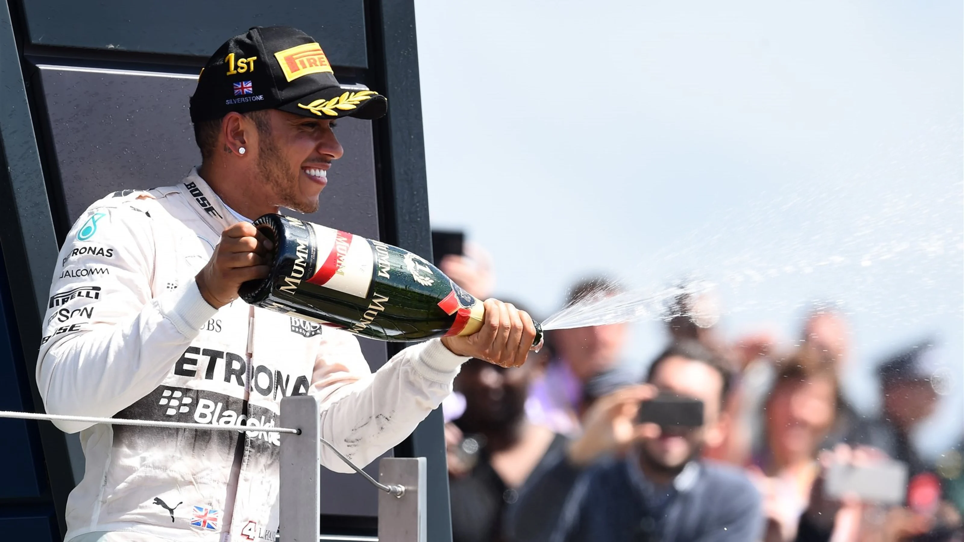 Race winner Lewis Hamilton (GBR) Mercedes AMG F1 celebrates on the podium with the champagne
