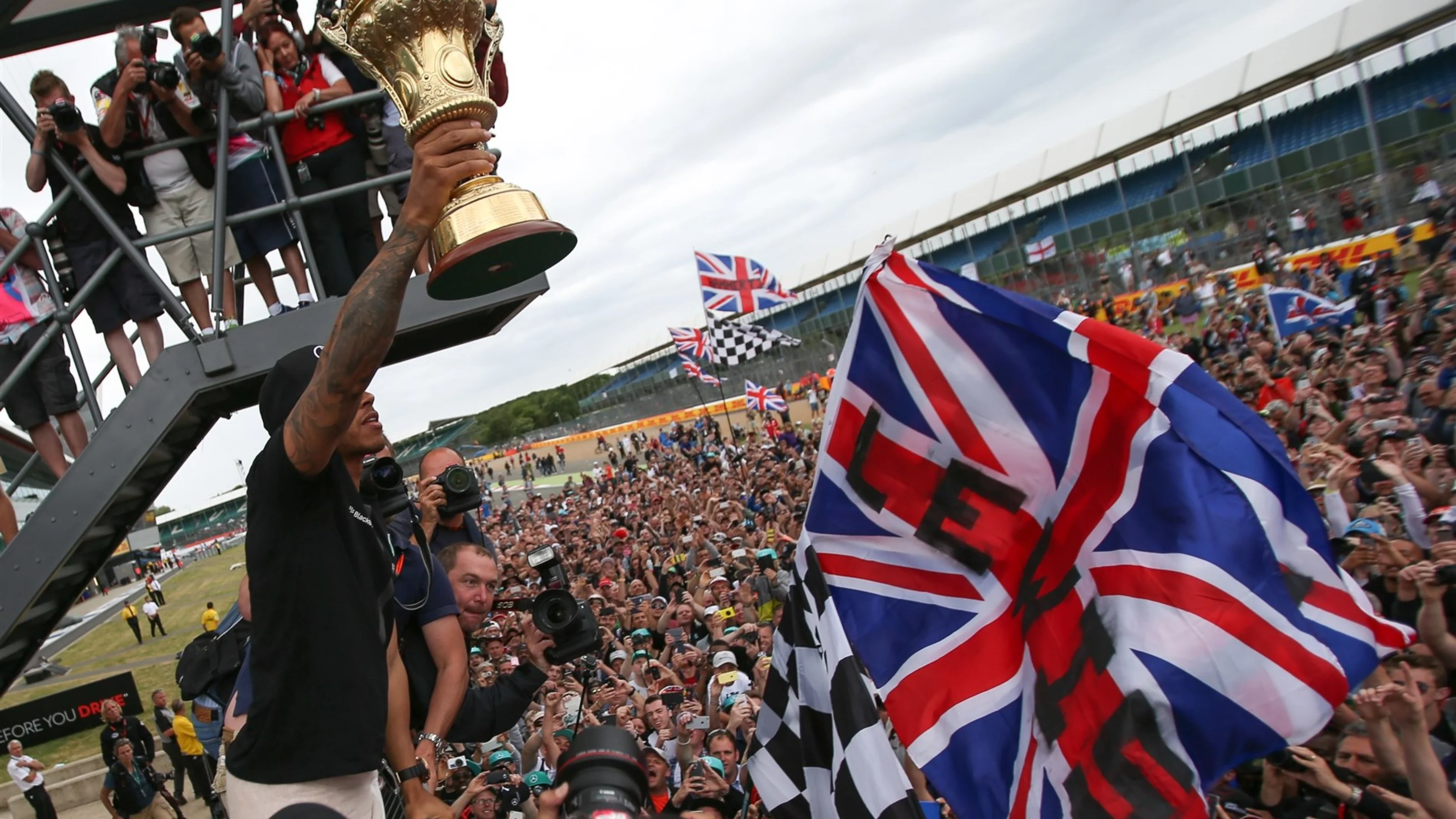 Race winner Lewis Hamilton (GBR) Mercedes AMG F1 celebrates with fans and trophy at Formula One
