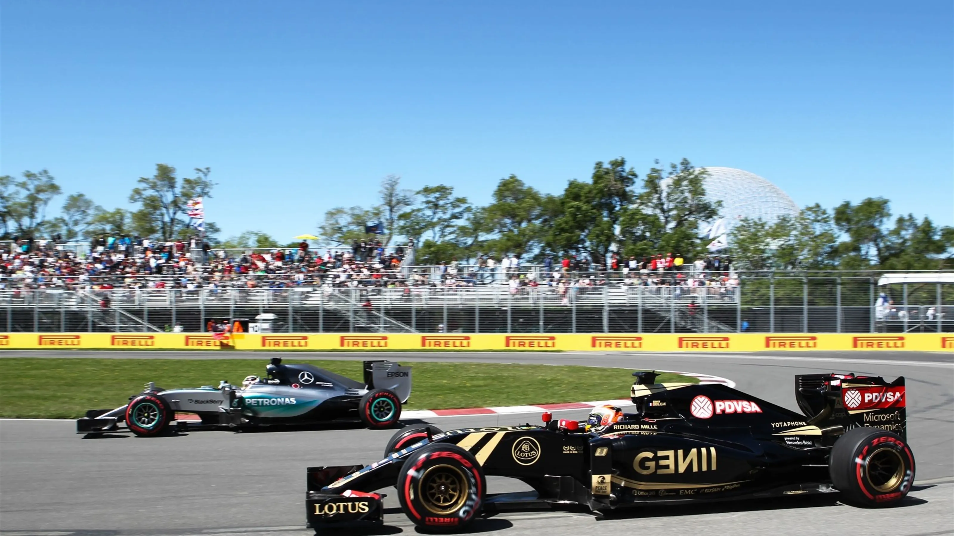 Romain Grosjean (FRA) Lotus E23 Hybrid and Lewis Hamilton (GBR) Mercedes AMG F1 W06 at Formula One