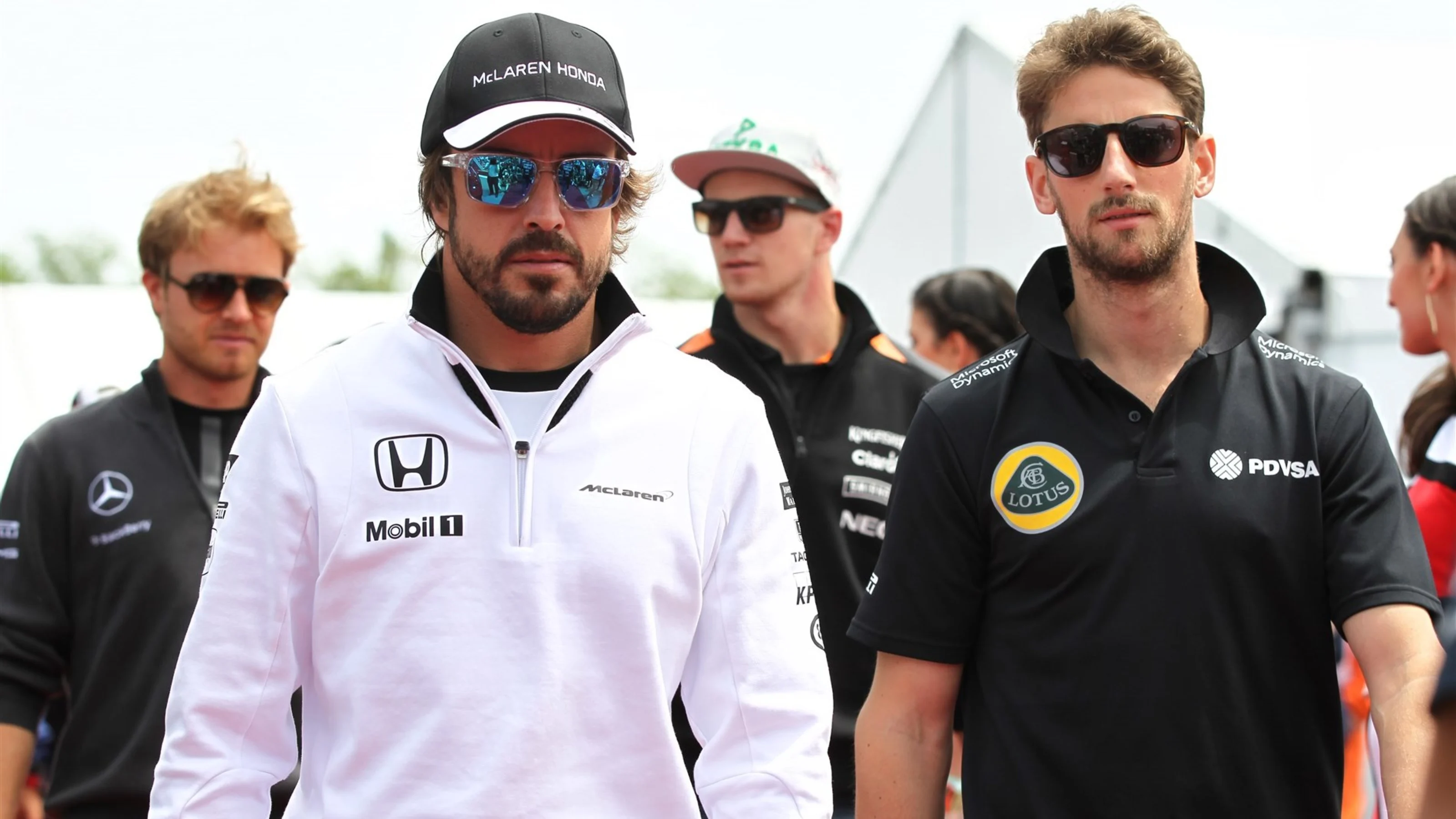 Fernando Alonso (ESP) McLaren and Romain Grosjean (FRA) Lotus F1 on the drivers parade at Formula