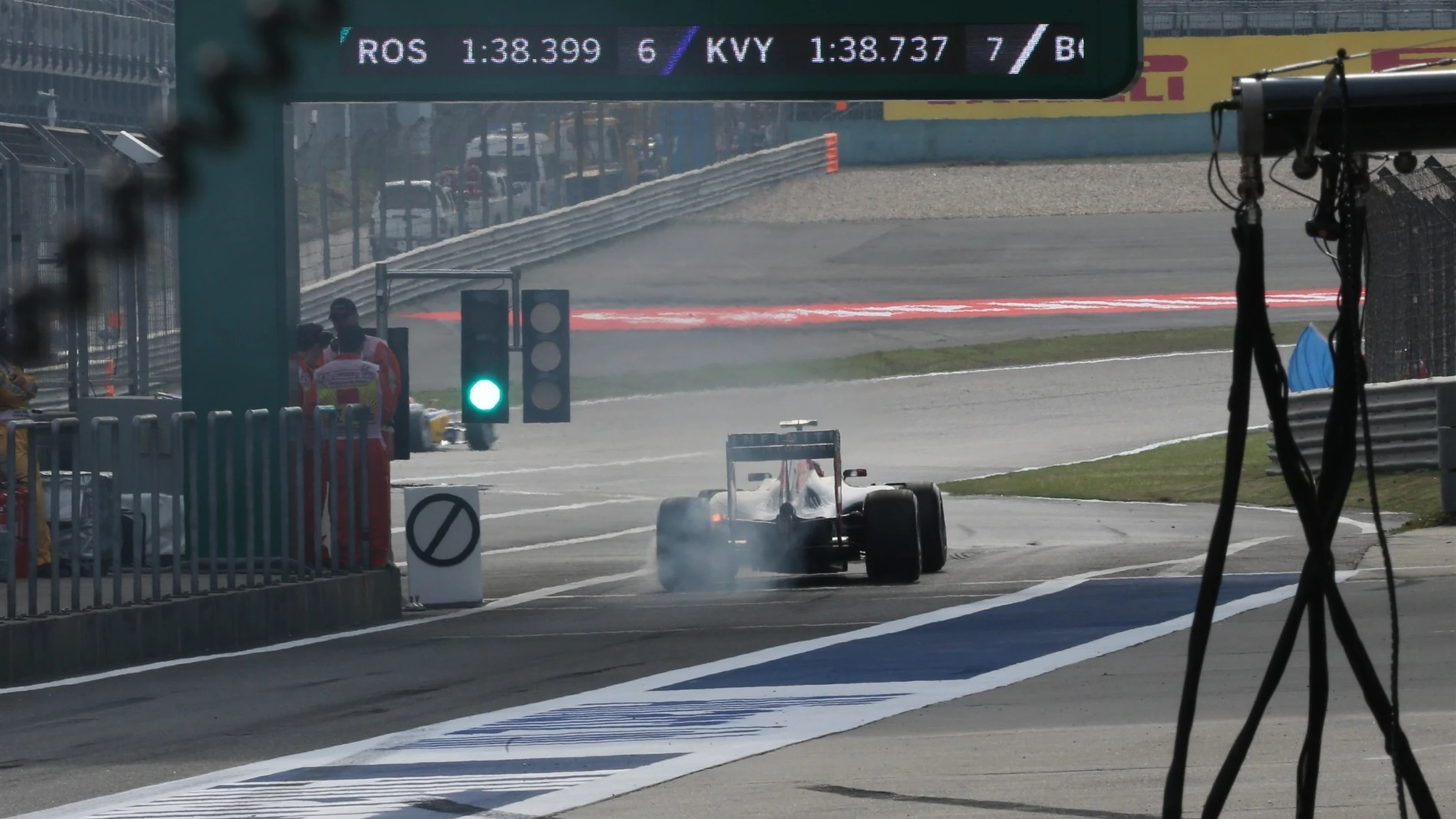 Daniil Kvyat (RUS) Red Bull Racing RB11 exits pit lane with his rear brakes on fire at Formula One