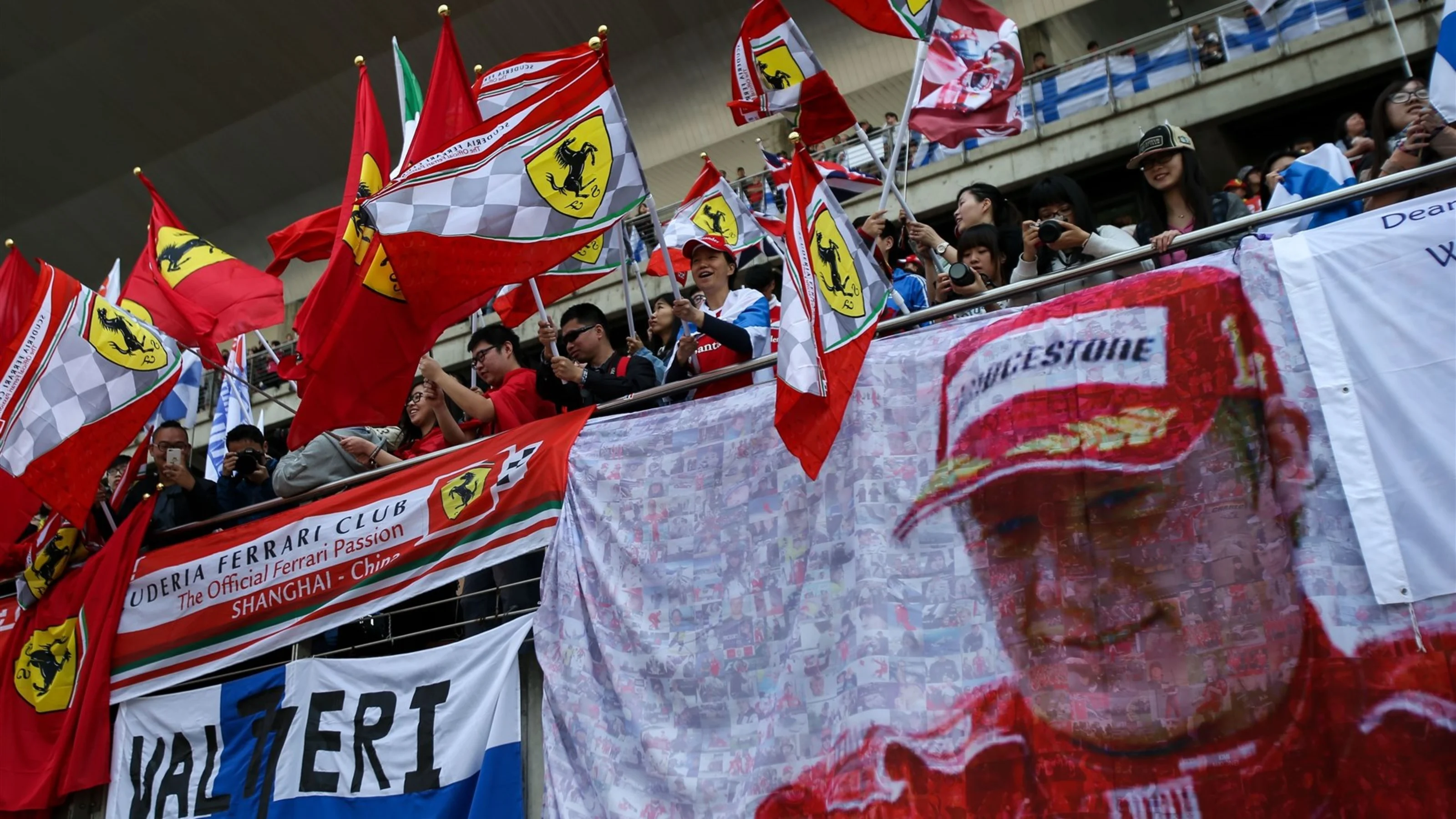 Kimi Raikkonen (FIN) Ferrari fans with flags on the main grandstand at Formula One World