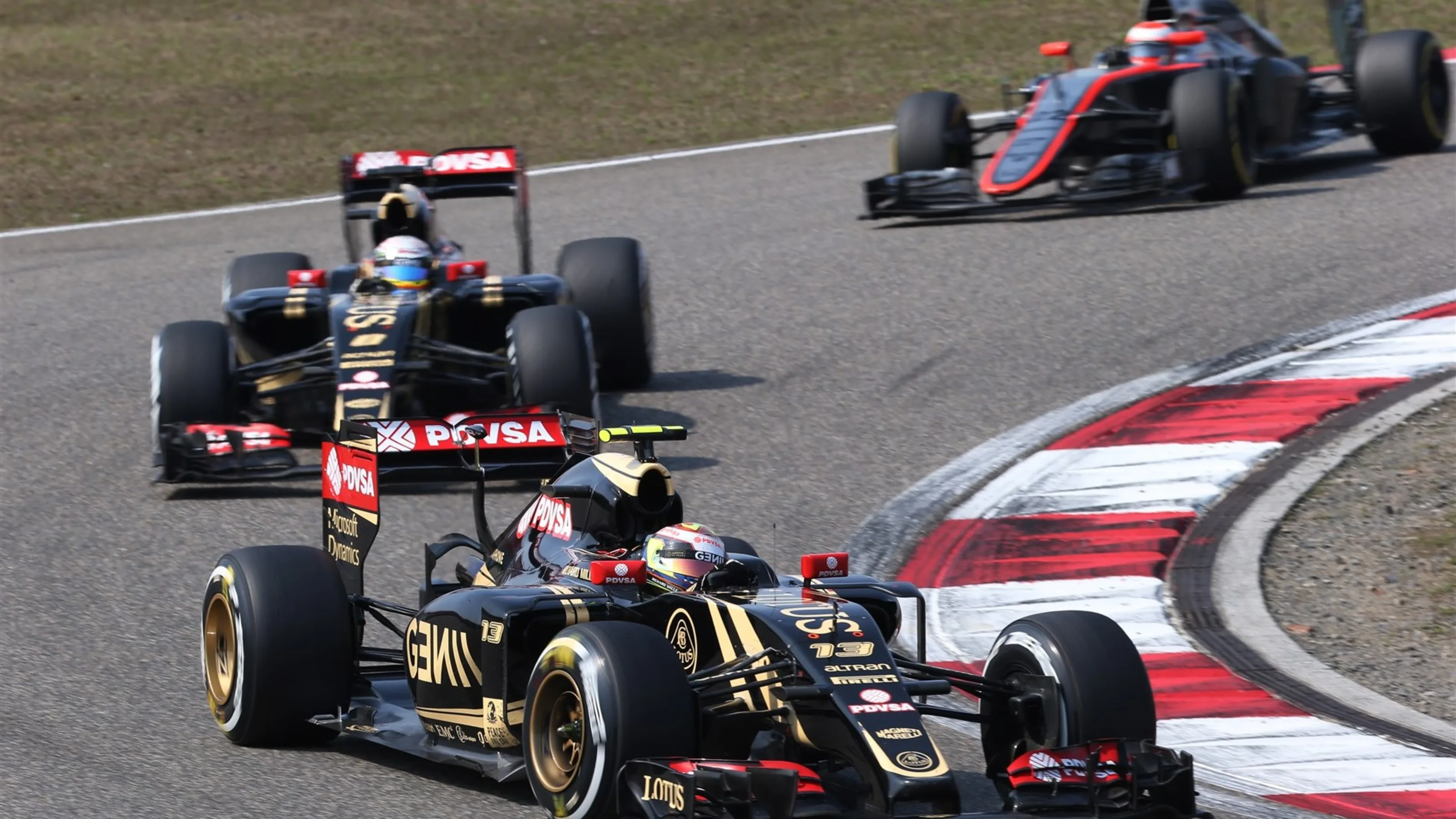 Pastor Maldonado (VEN) Lotus E23 Hybrid leads Romain Grosjean (FRA) Lotus E23 Hybrid at Formula One