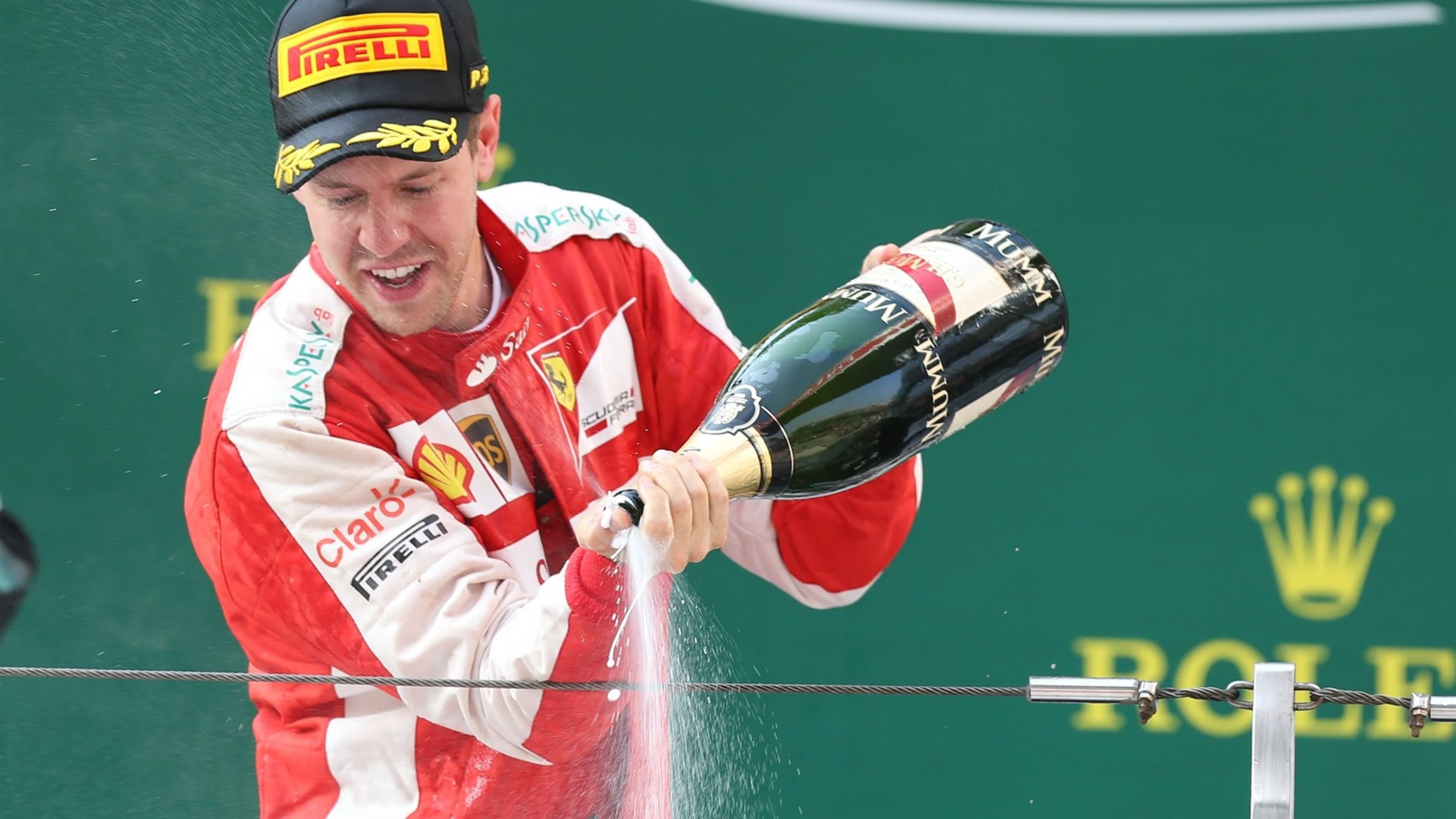 Sebastian Vettel (GER) Ferrari celebrates with champagne on the podium at Formula One World